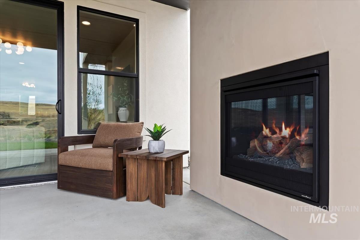 Sitting room with finished concrete floors and a glass covered fireplace