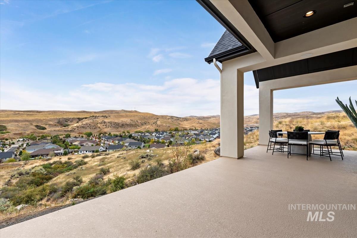 View of patio featuring outdoor dining area and a mountain view