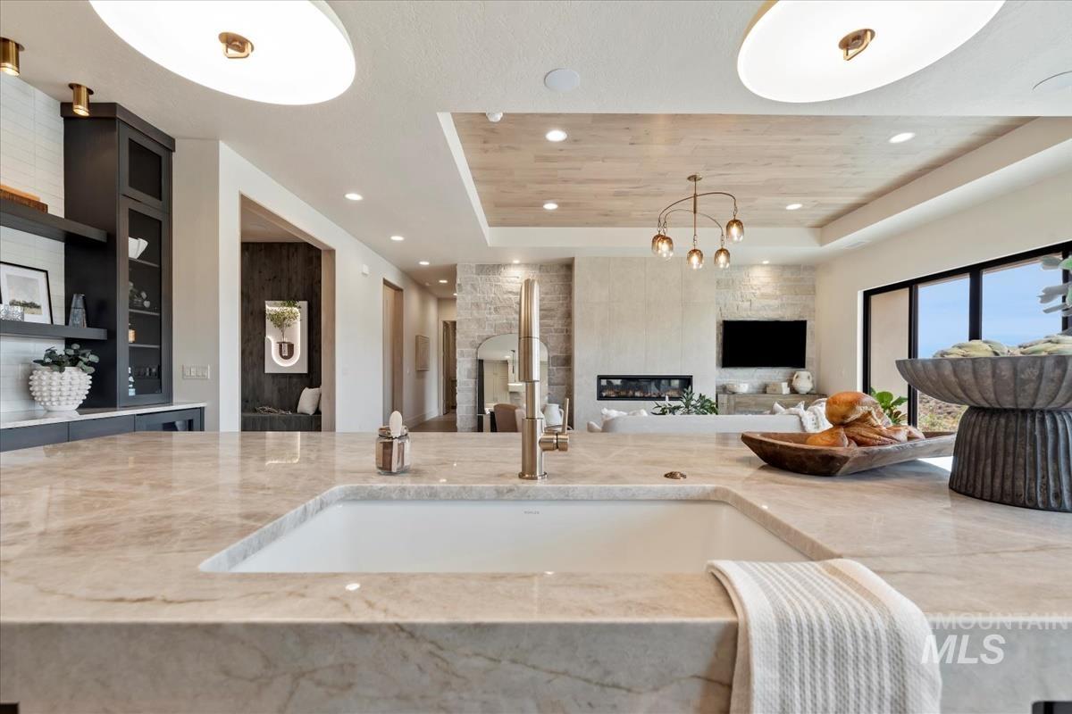 Living room featuring a tray ceiling and recessed lighting