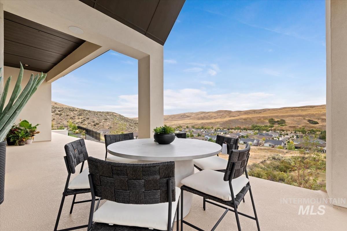 View of patio / terrace featuring outdoor dining space and a mountain view
