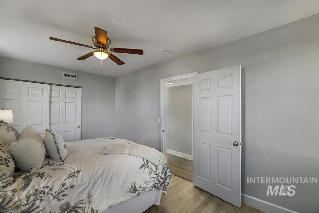 Bedroom featuring light wood-style flooring, a closet, and a ceiling fan