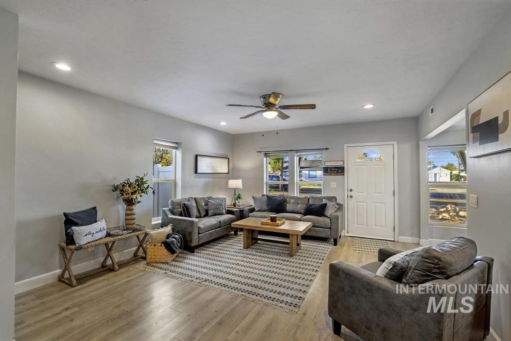 Living room with recessed lighting, light wood-style floors, and a ceiling fan
