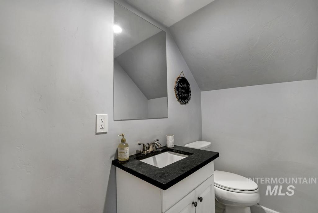 Bathroom with lofted ceiling and vanity