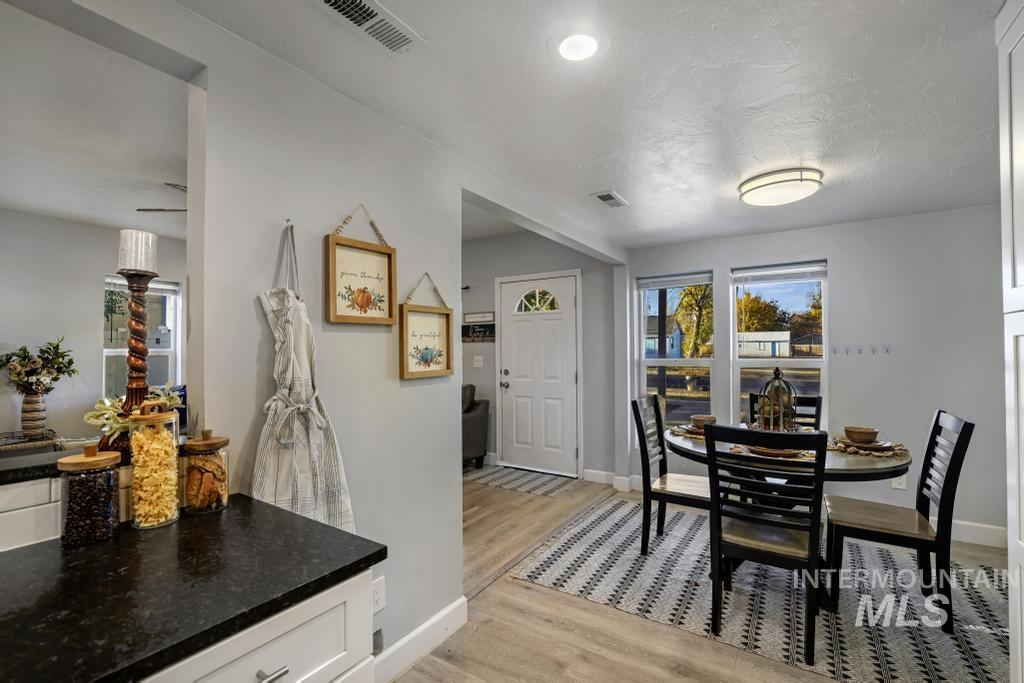 Dining space featuring light wood-style floors and a textured ceiling