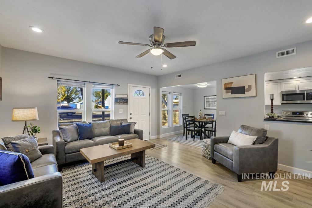 Living area with recessed lighting, light wood-type flooring, plenty of natural light, and a ceiling fan