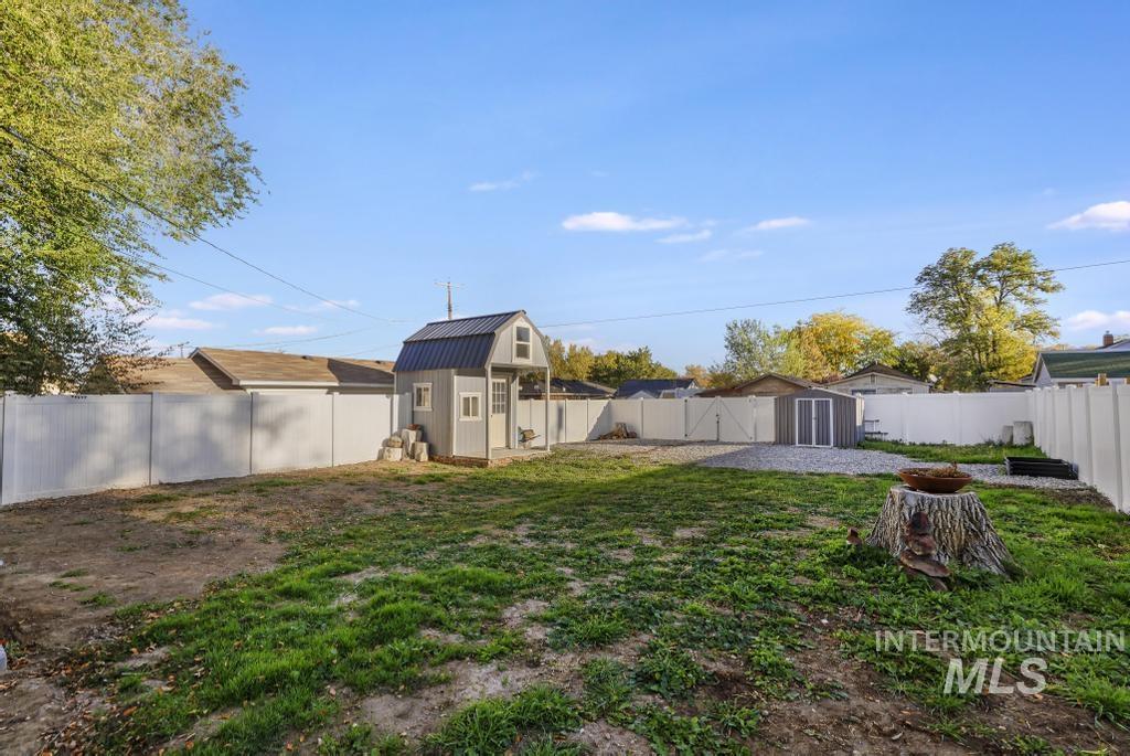 Fenced backyard with a storage shed