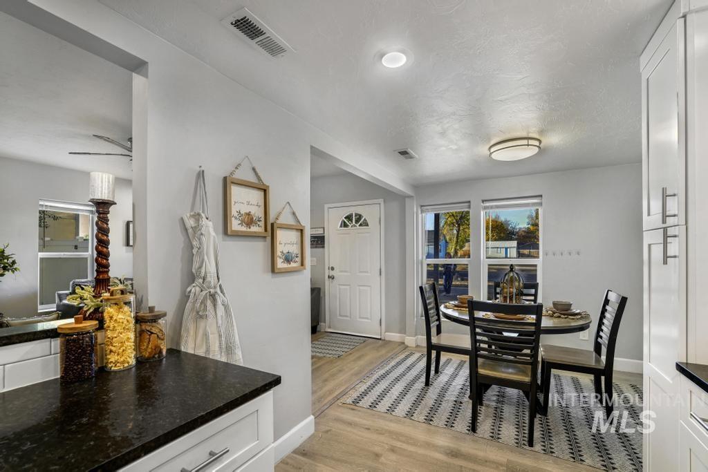 Dining space with light wood-style floors and baseboards