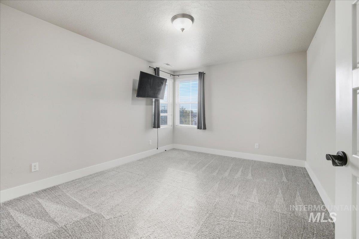 Spare room with carpet flooring and a textured ceiling
