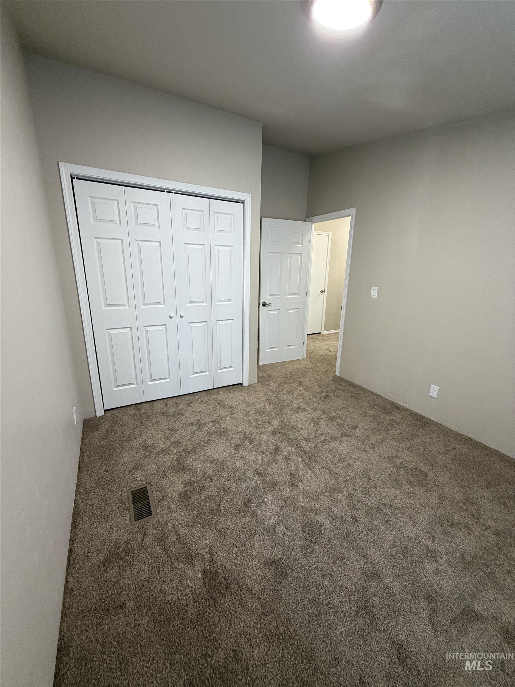Unfurnished bedroom featuring carpet floors and a closet