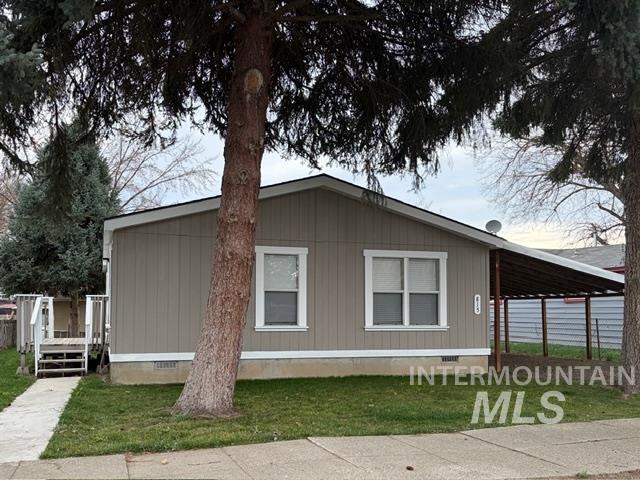 View of home's exterior featuring crawl space, an attached carport, a yard, and a deck