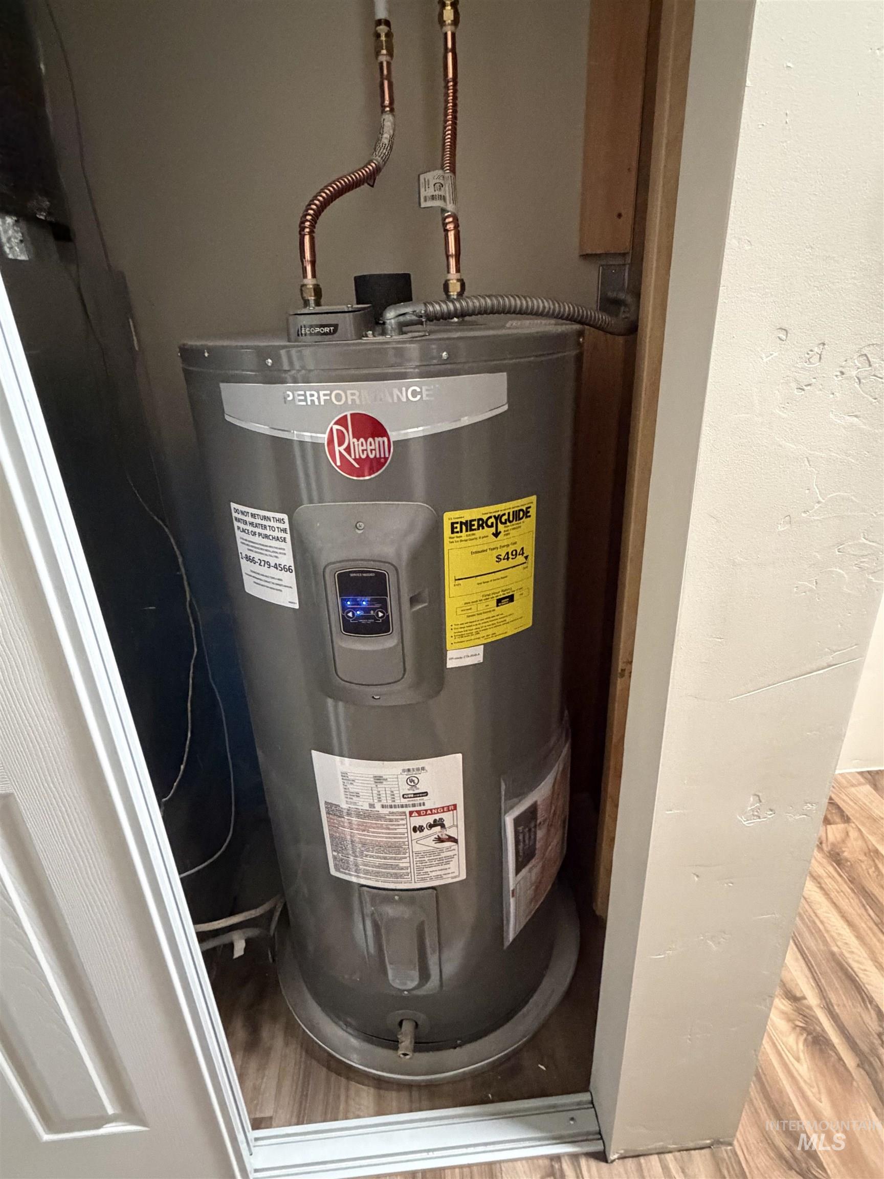Utility room featuring water heater