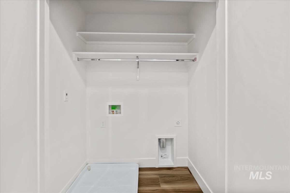 Laundry area featuring dark wood-style flooring and washer hookup