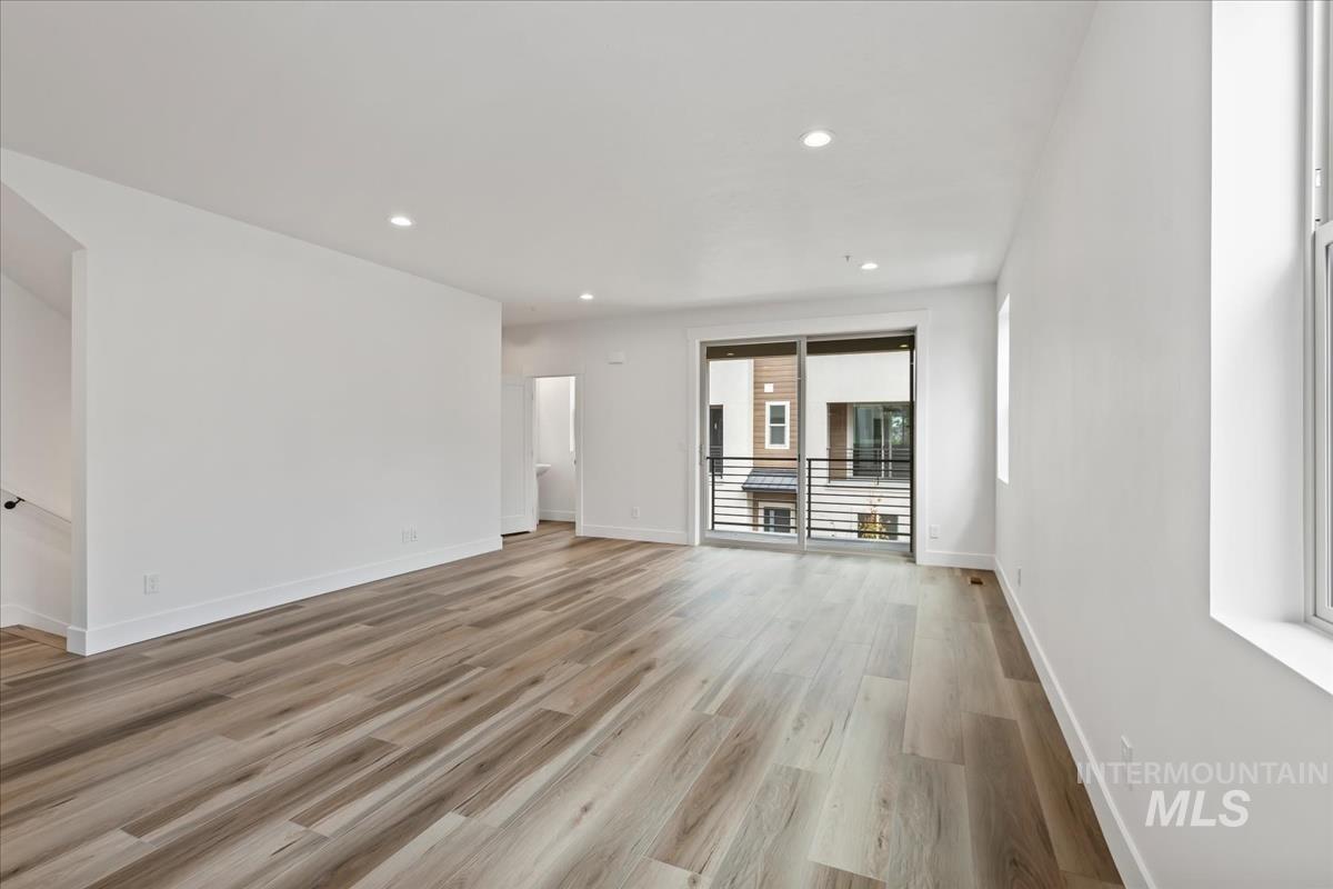 Unfurnished living room with recessed lighting and light wood finished floors
