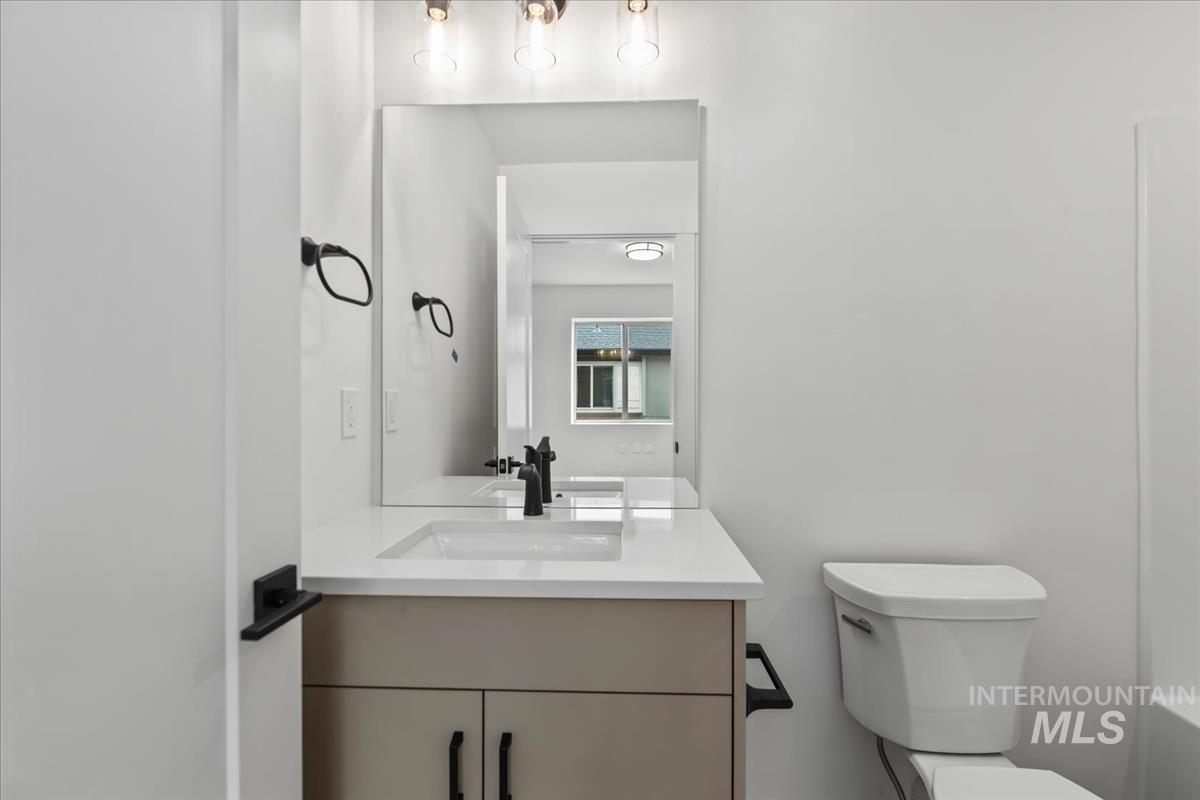 Bathroom featuring vanity and toilet