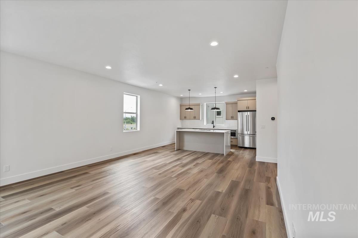 Unfurnished living room featuring recessed lighting and light wood-style flooring