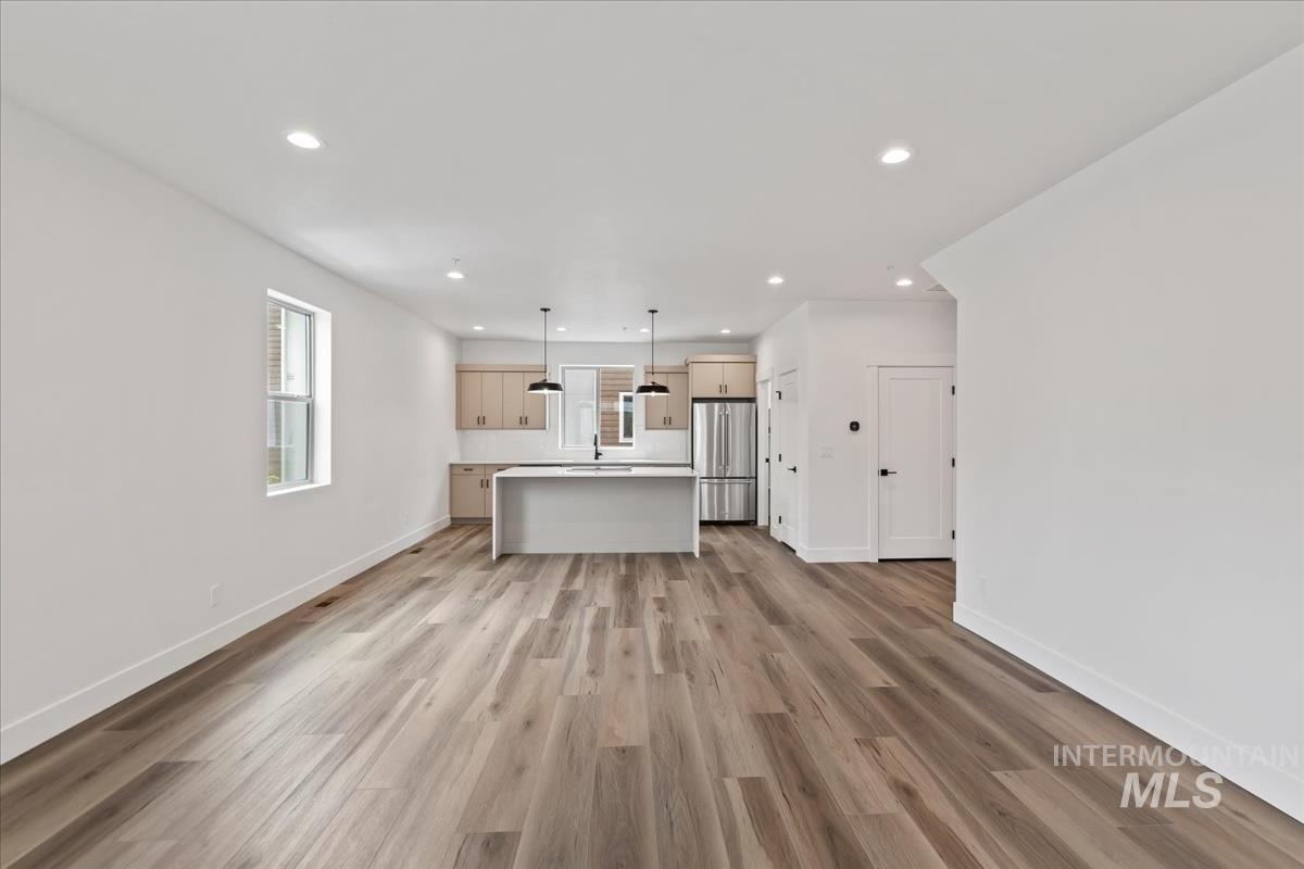 Unfurnished living room with recessed lighting and light wood-style floors