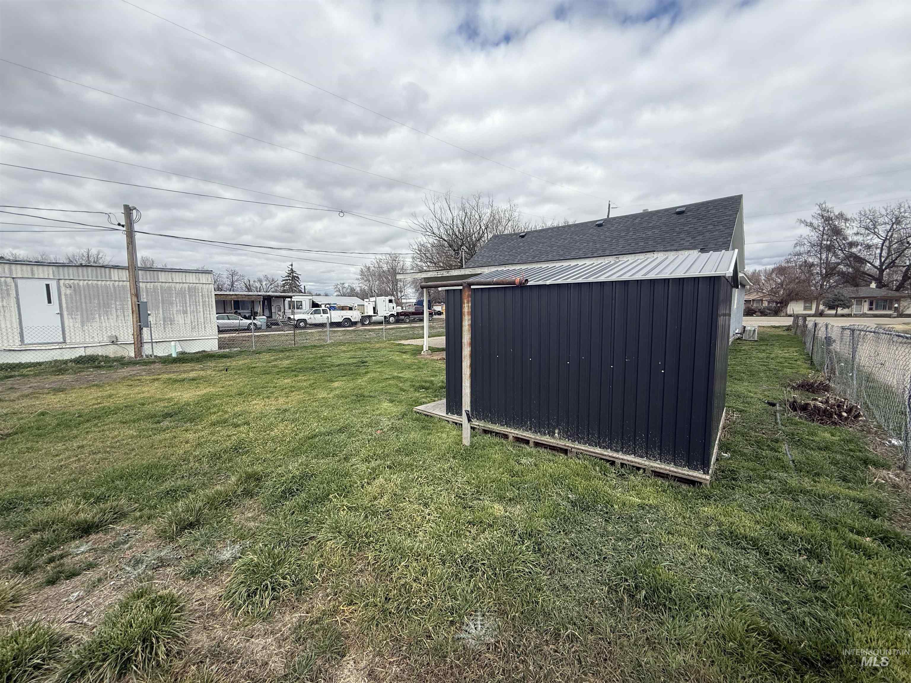 Fenced backyard with a storage shed