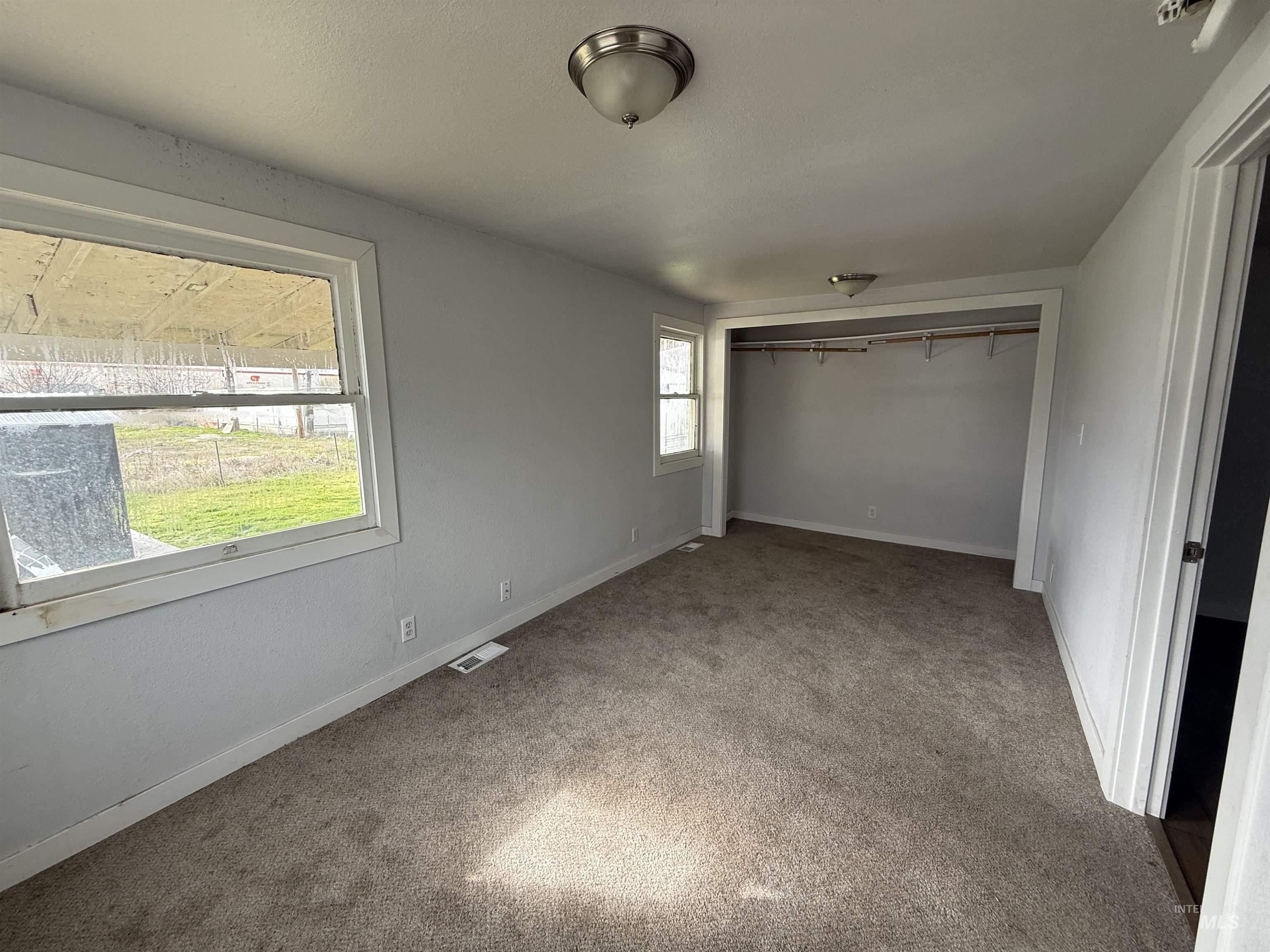Unfurnished bedroom featuring a closet and carpet floors
