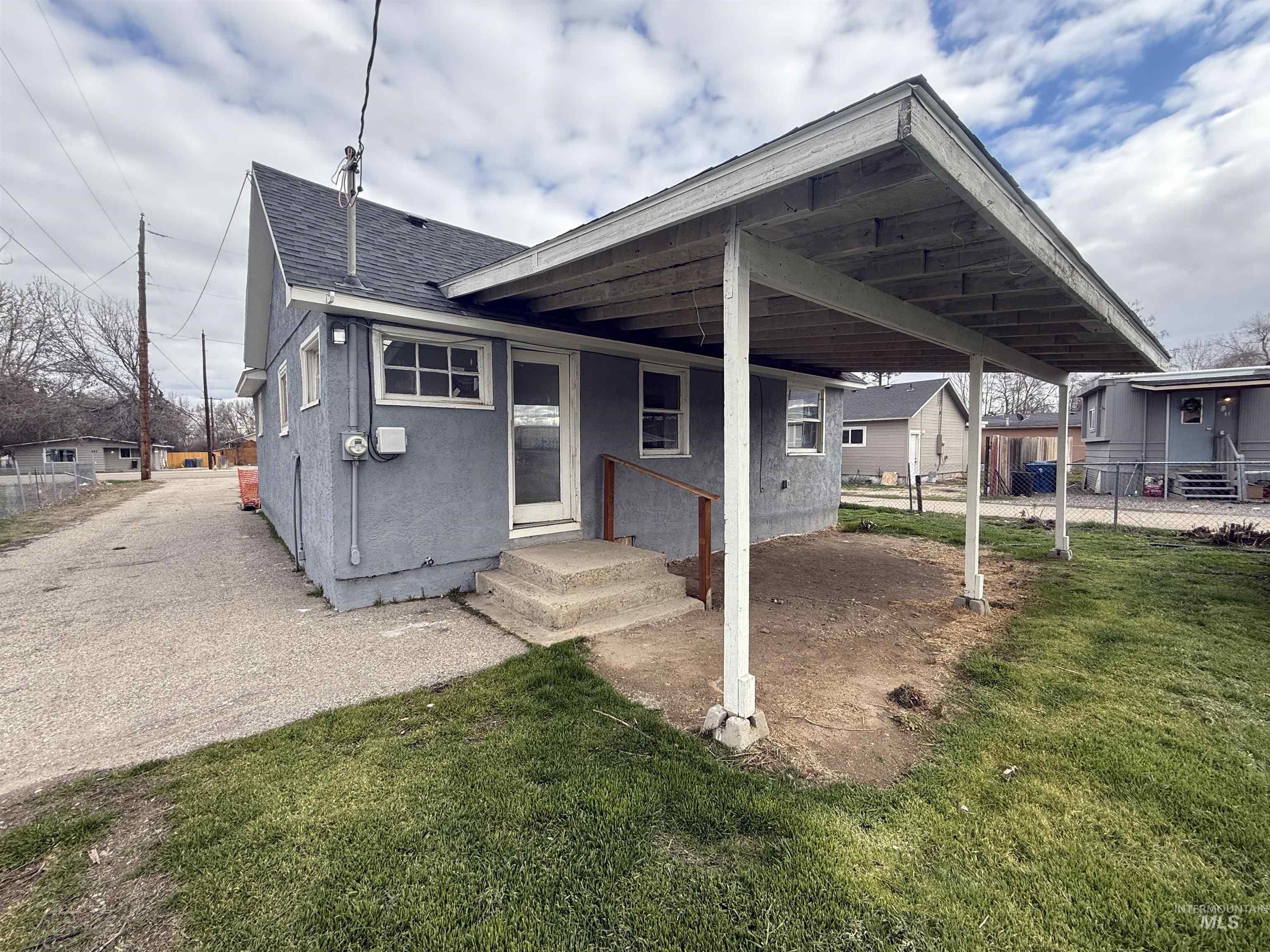 Back of property with roof with shingles