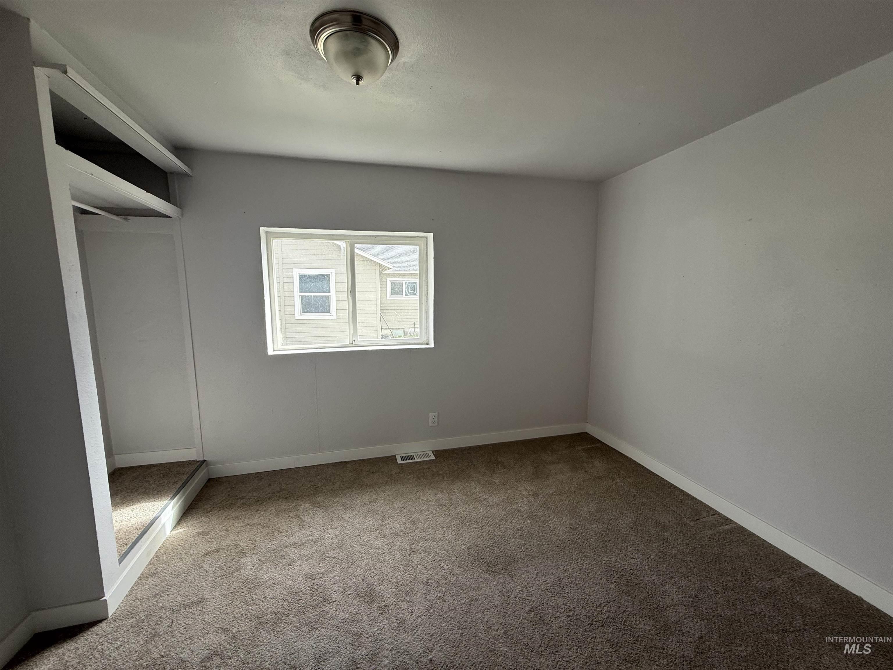 Unfurnished bedroom featuring a closet and carpet flooring