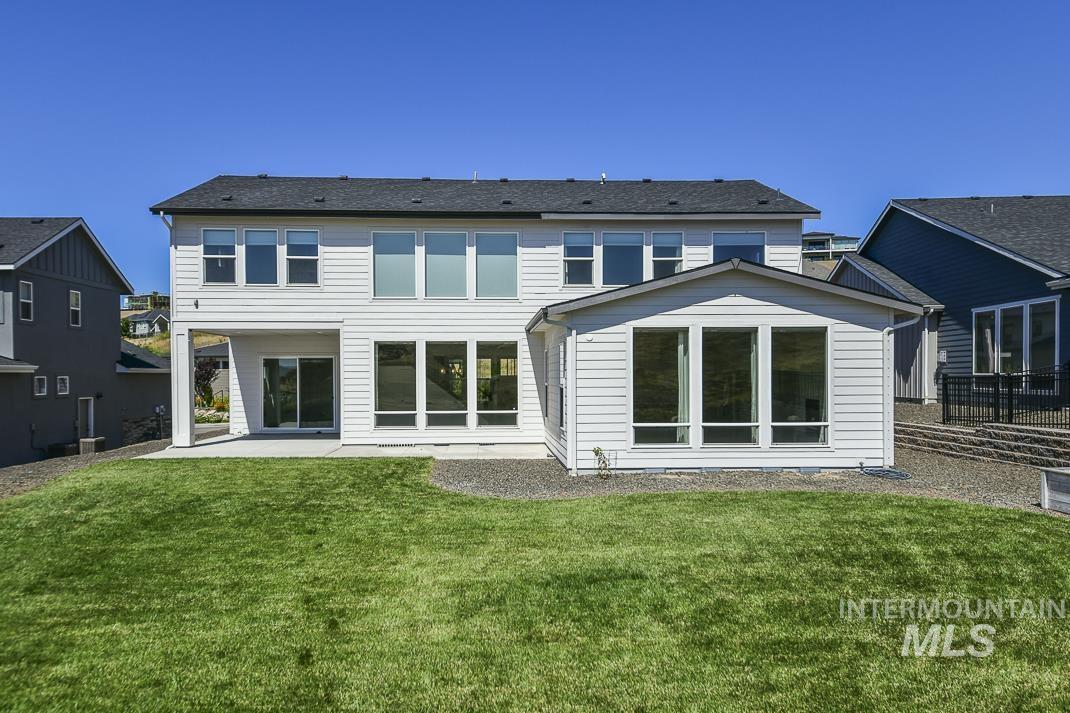 Rear view of house with a patio area and a yard