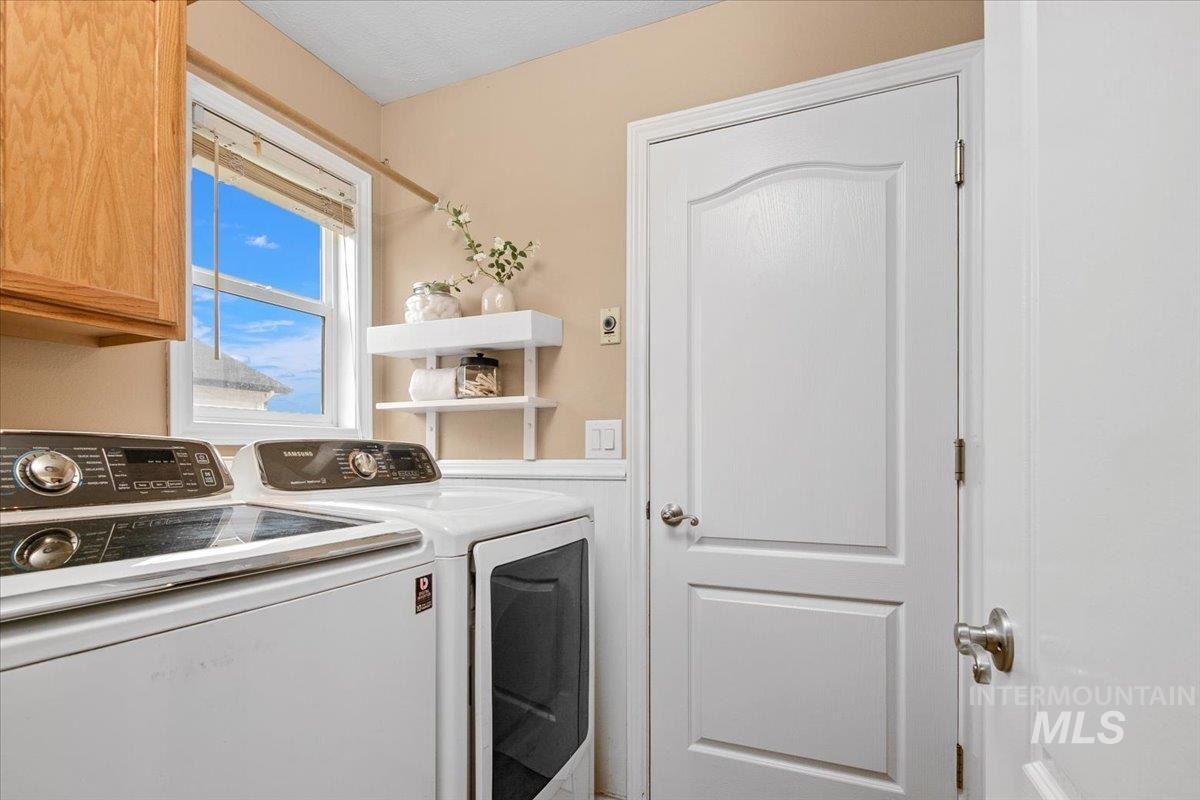 Laundry room featuring washer and dryer and cabinet space