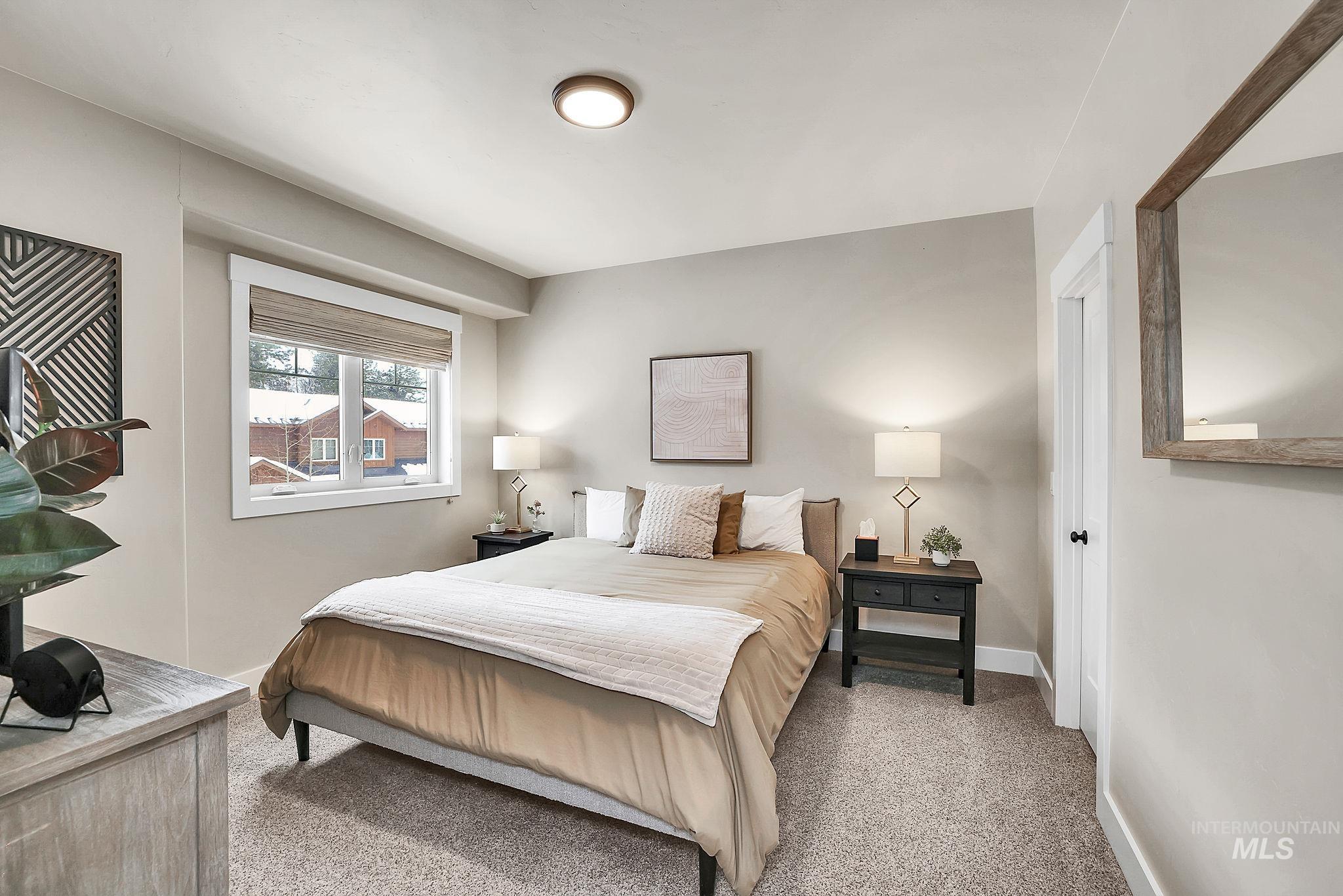 Bedroom featuring light colored carpet