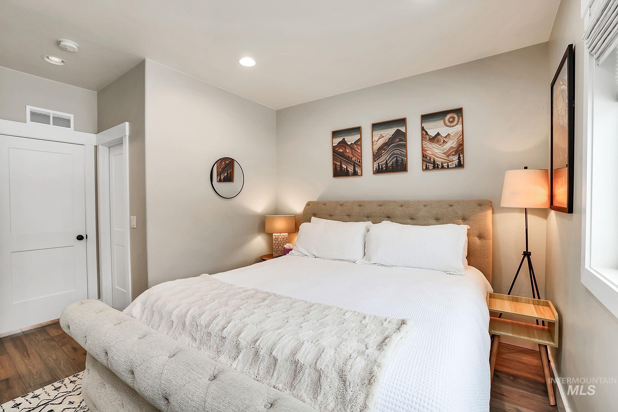 Bedroom with wood finished floors and recessed lighting