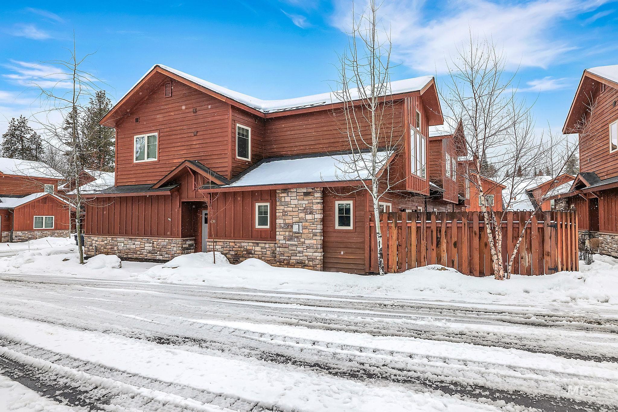 View of front of property with stone siding and board and batten siding