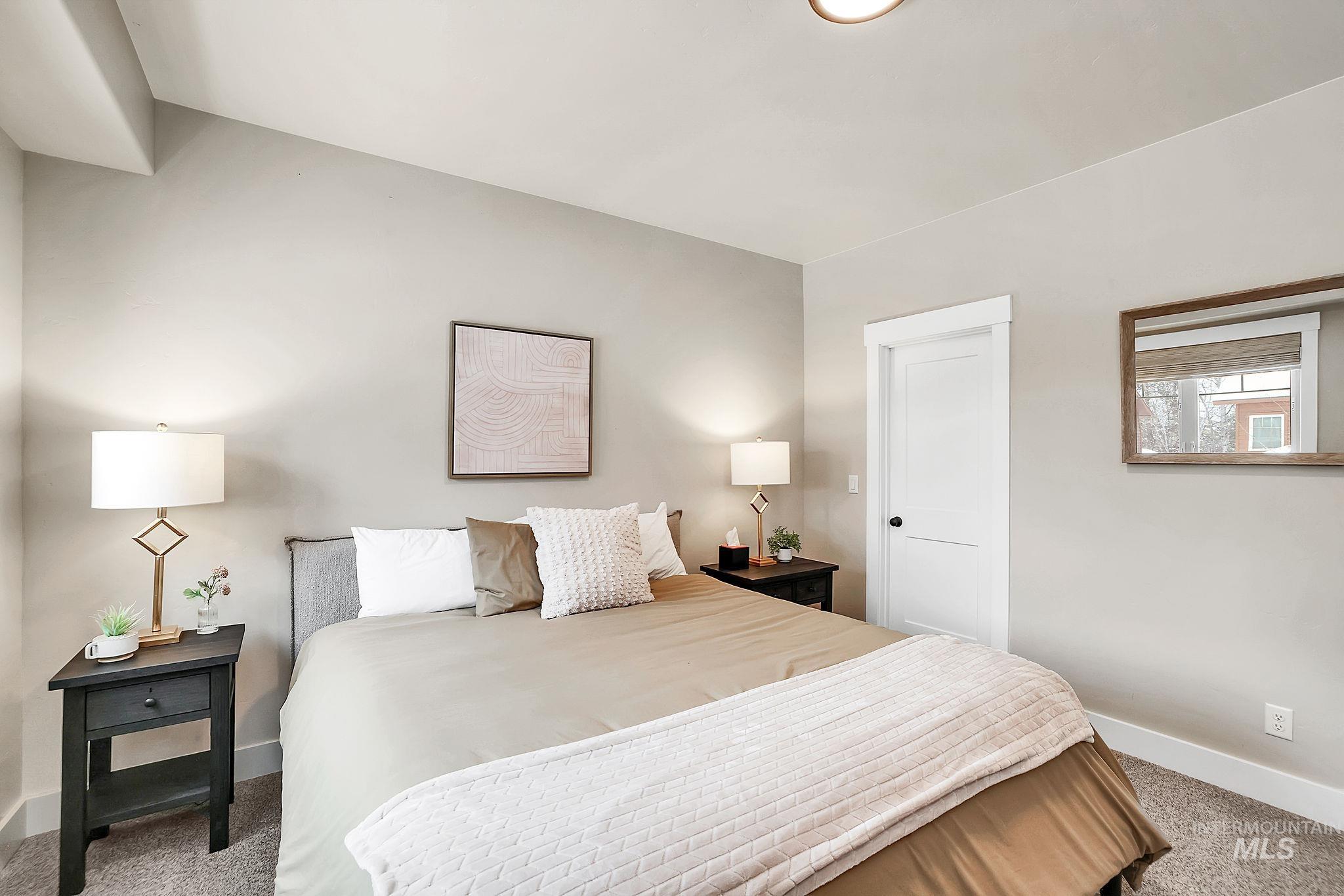Carpeted bedroom featuring baseboards