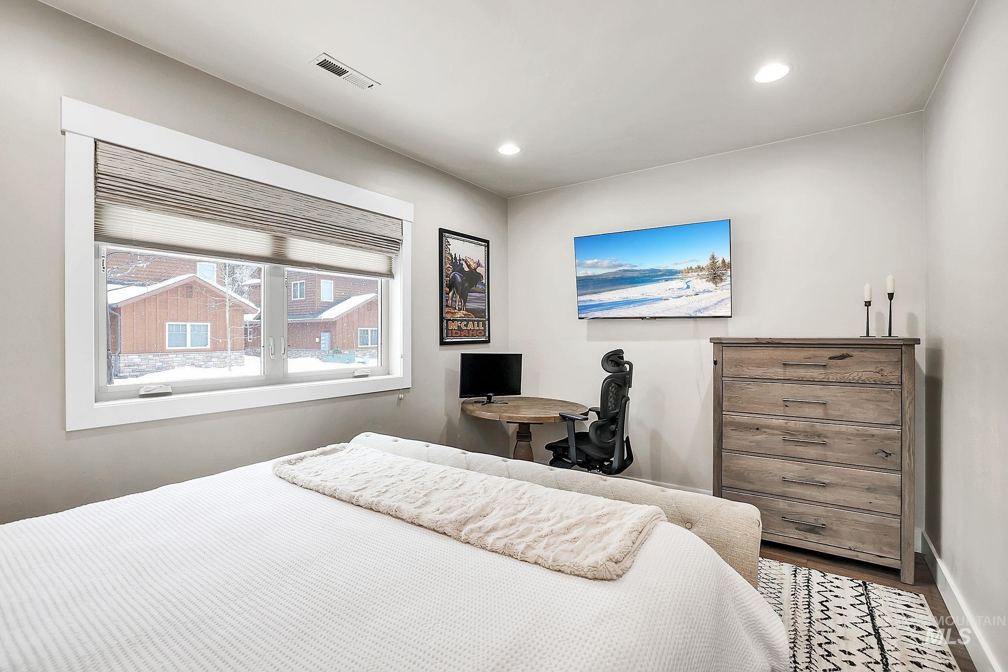 Bedroom featuring wood finished floors, recessed lighting, and a desk