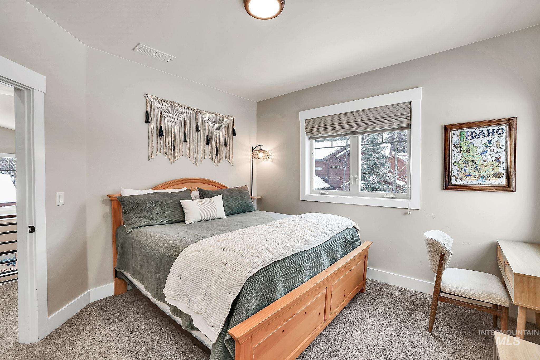 Bedroom with carpet and baseboards