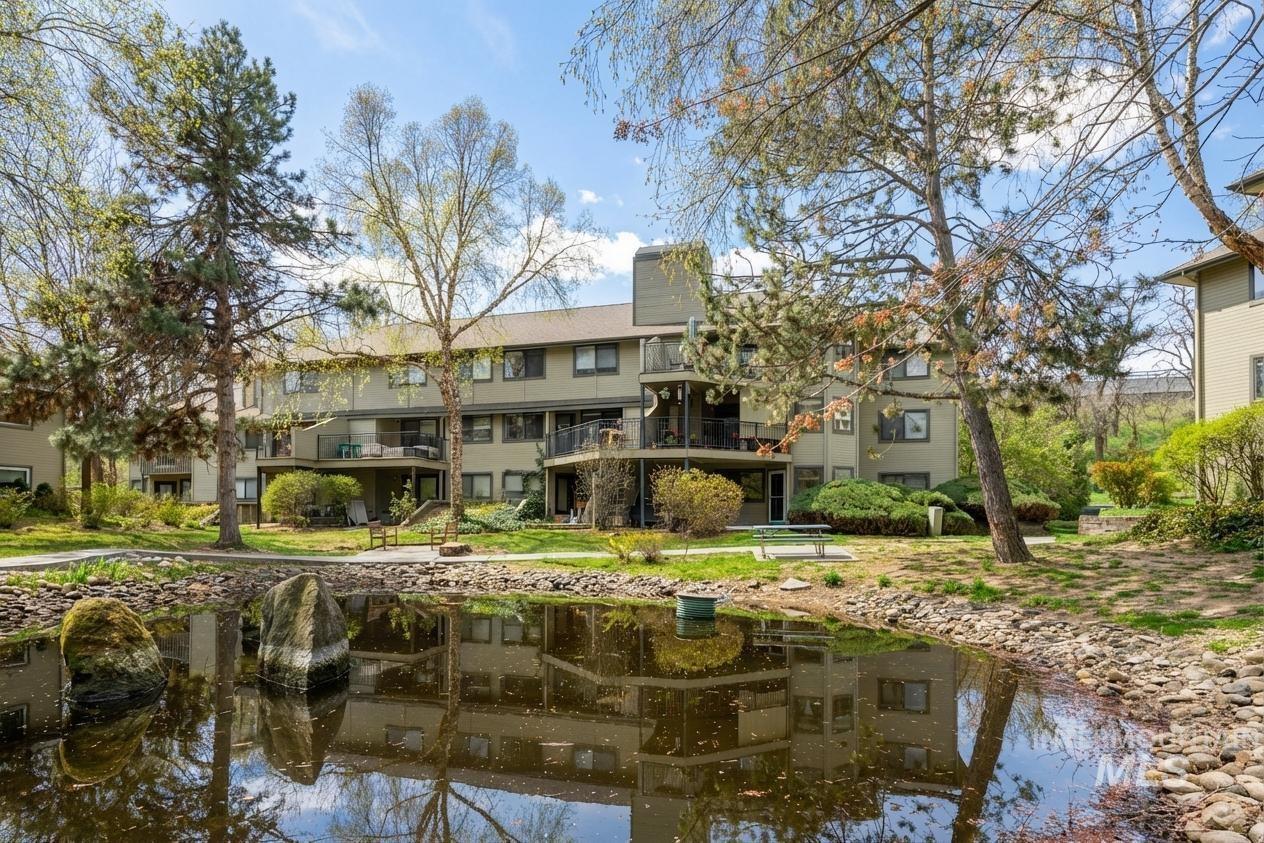 View of apartment building / complex with a water view