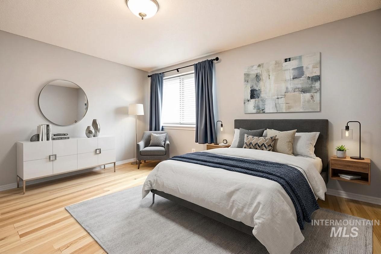 Bedroom with light wood-type flooring and baseboards