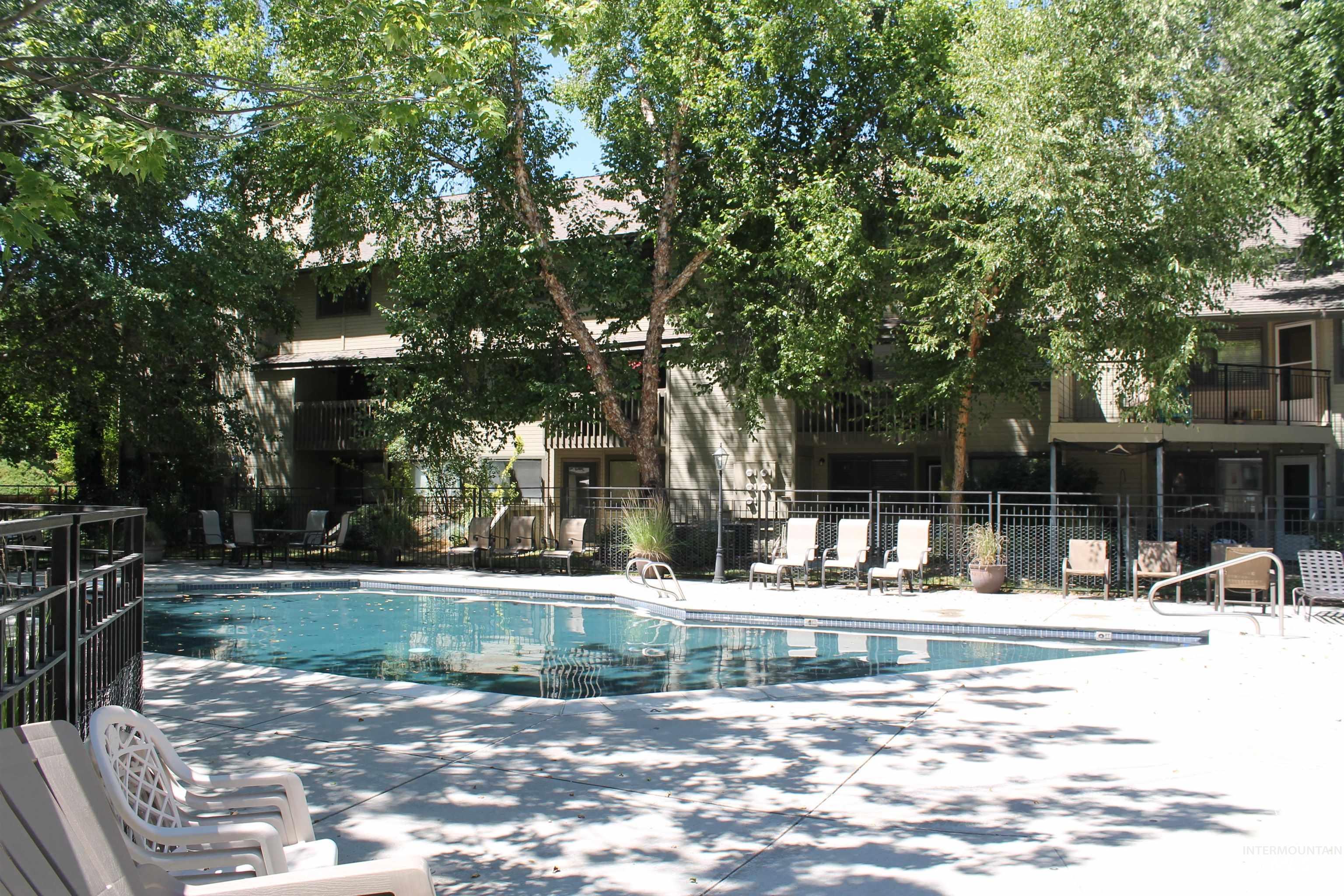 Community pool with a patio