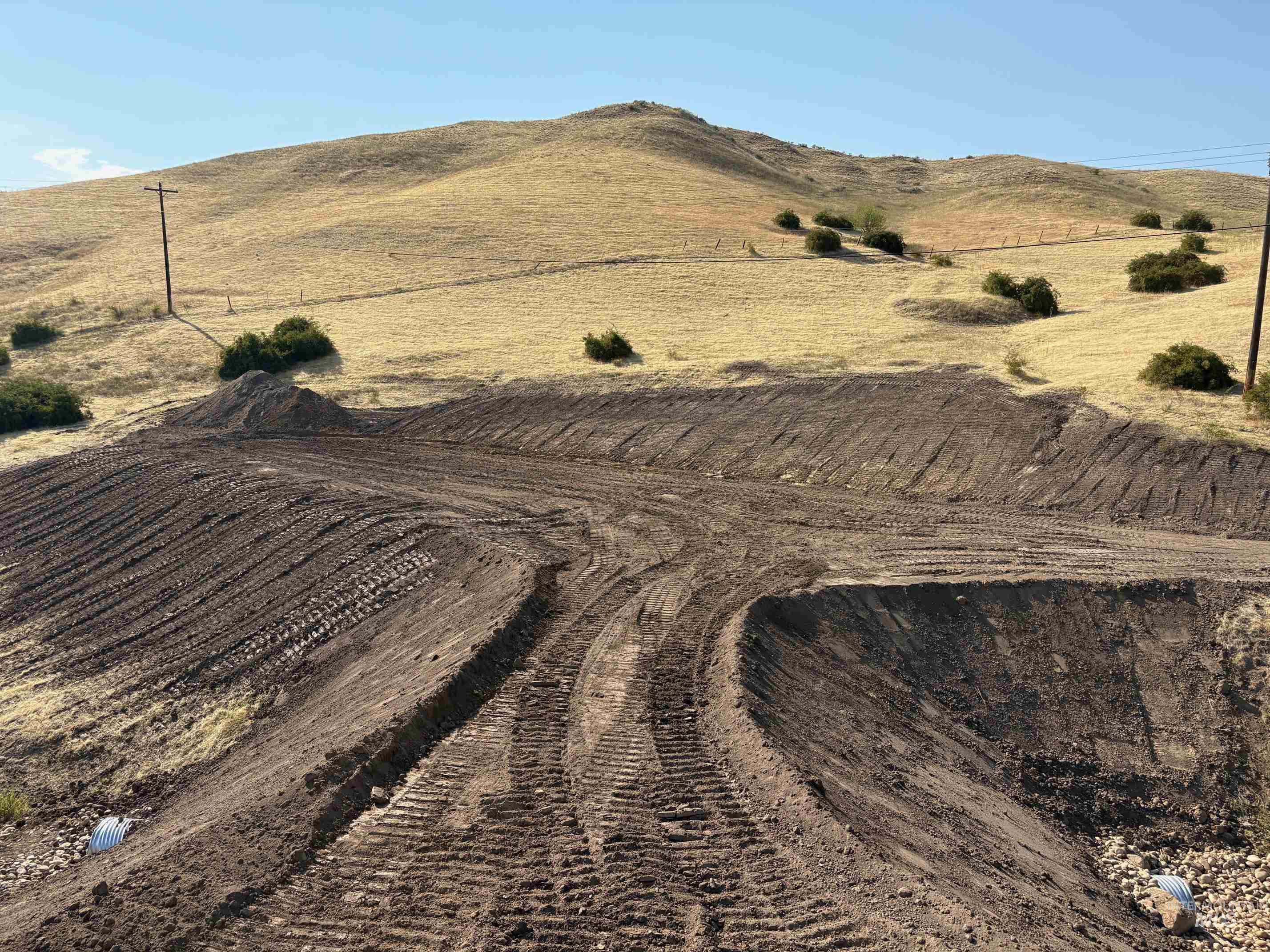 Aerial overview of property's location with rural landscape and a mountainous background