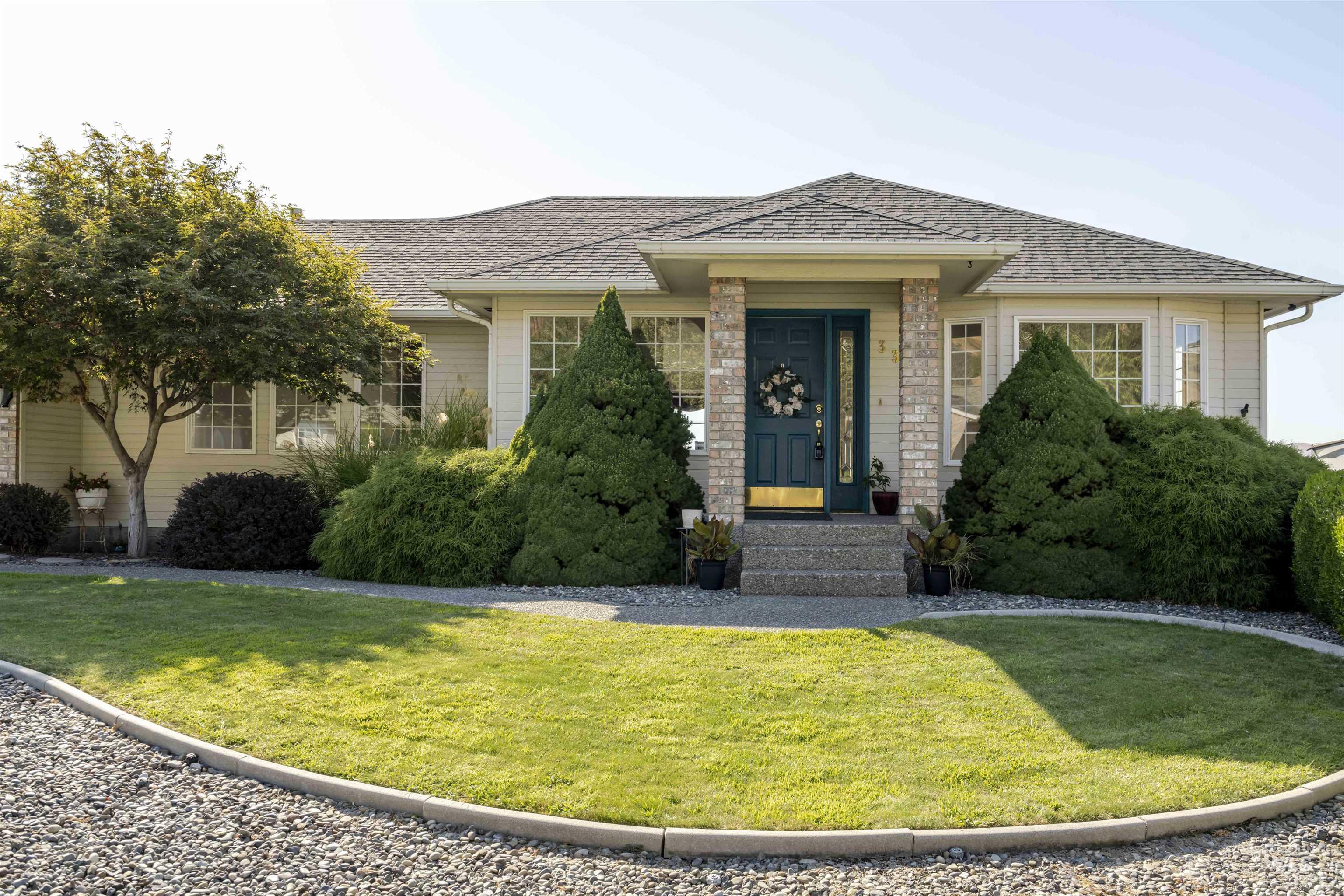 Single story home with roof with shingles and a front yard