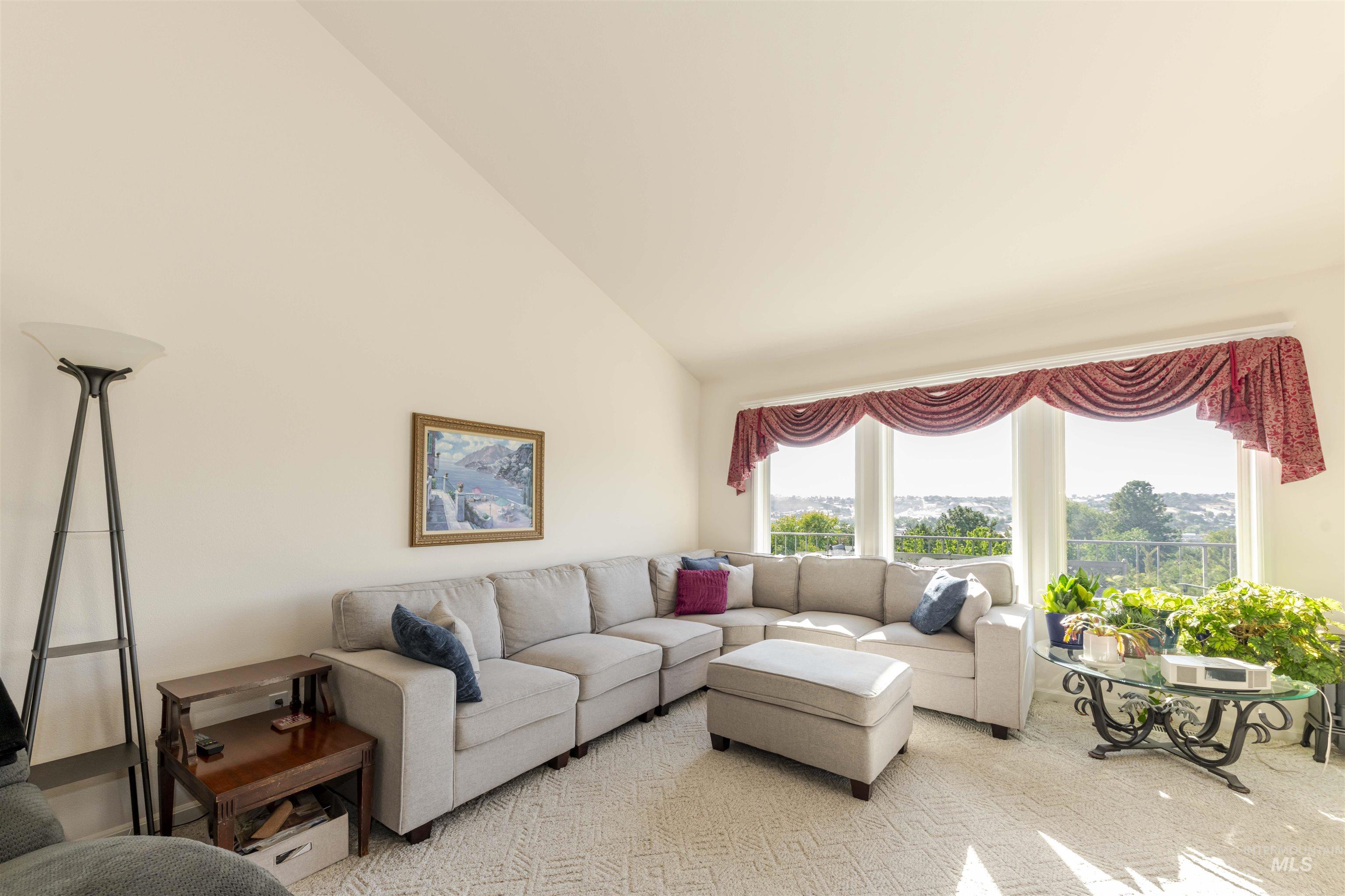 Living room with high vaulted ceiling