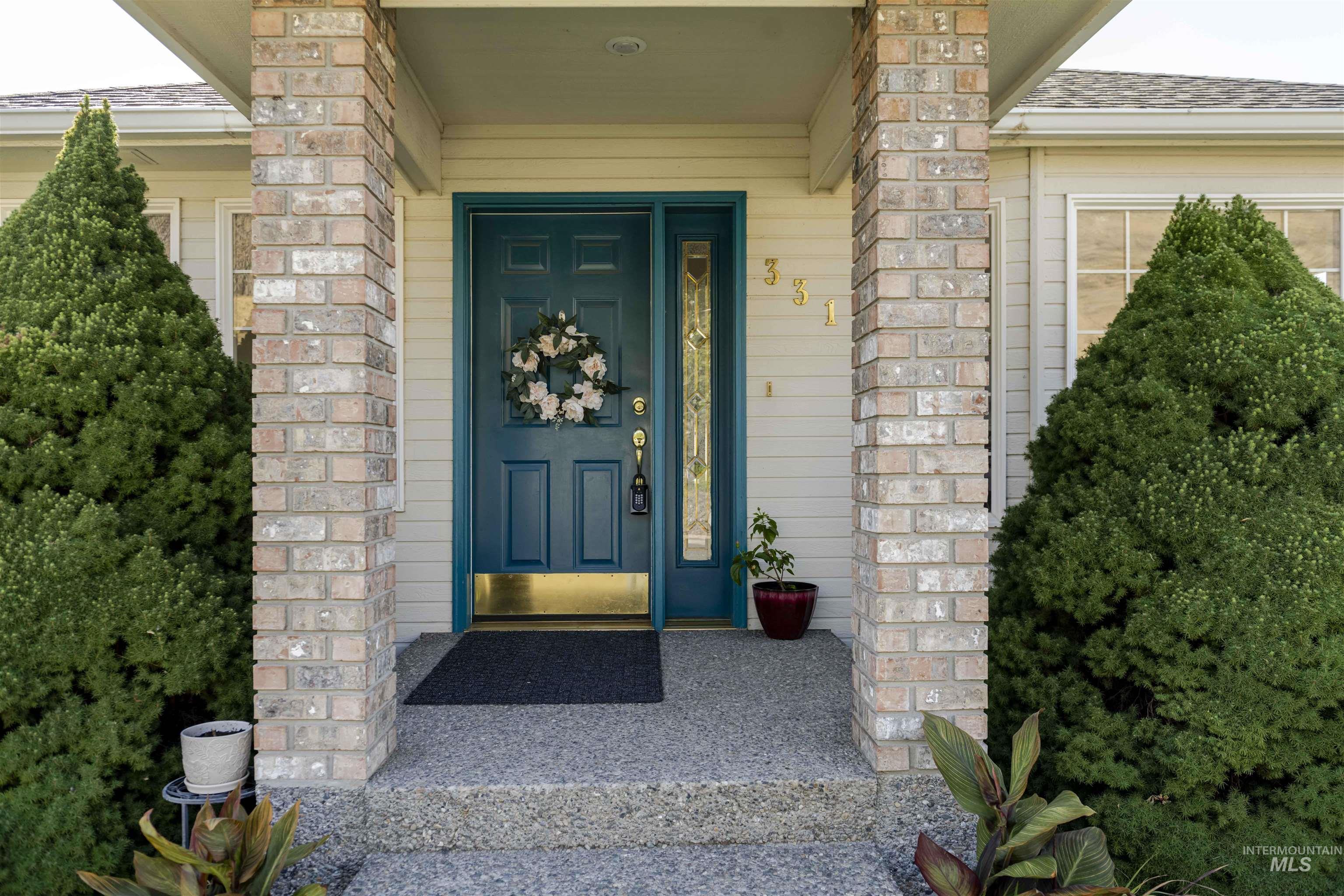 Doorway to property with a shingled roof