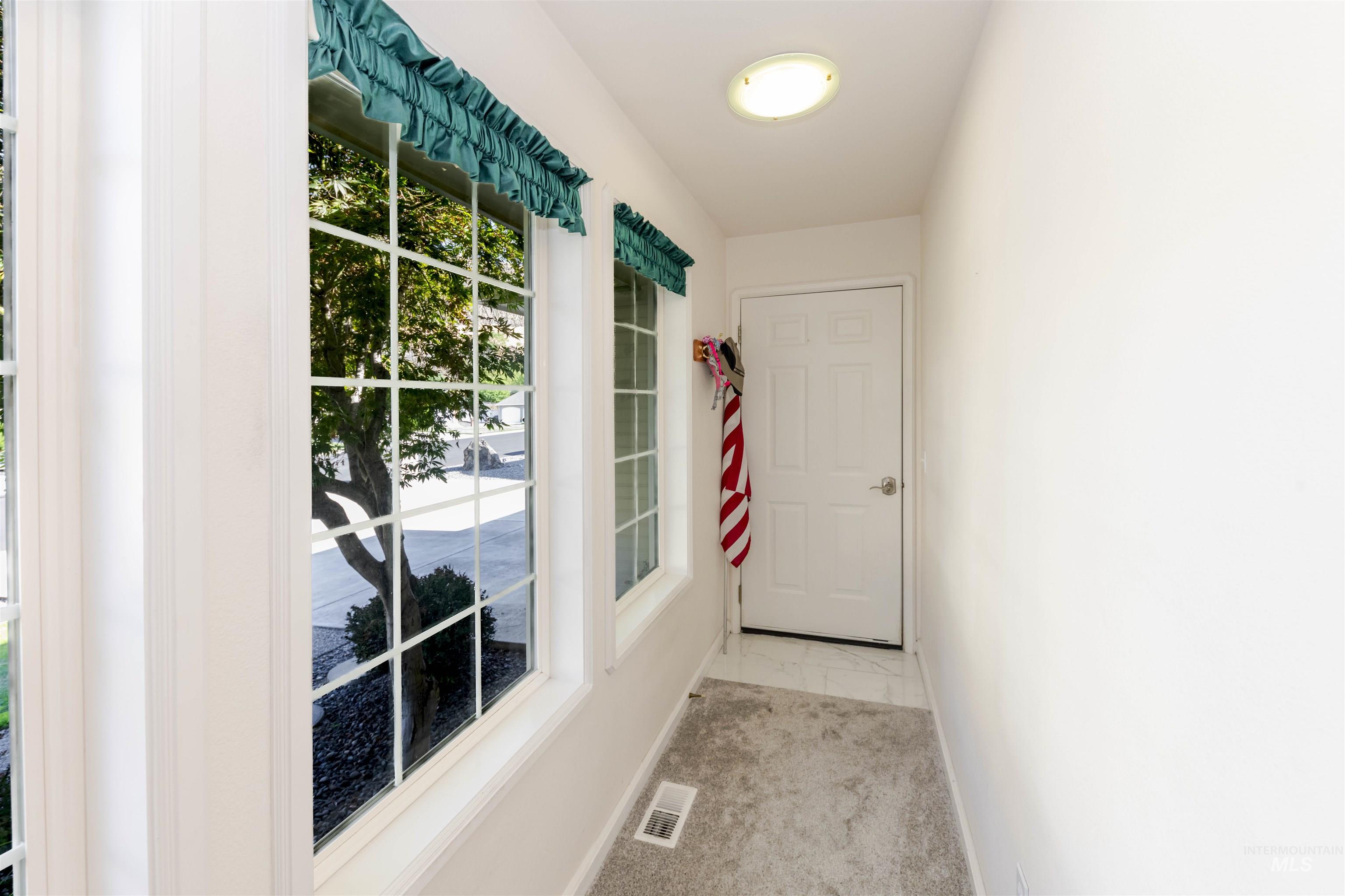 Doorway to outside with baseboards and marble finish floors