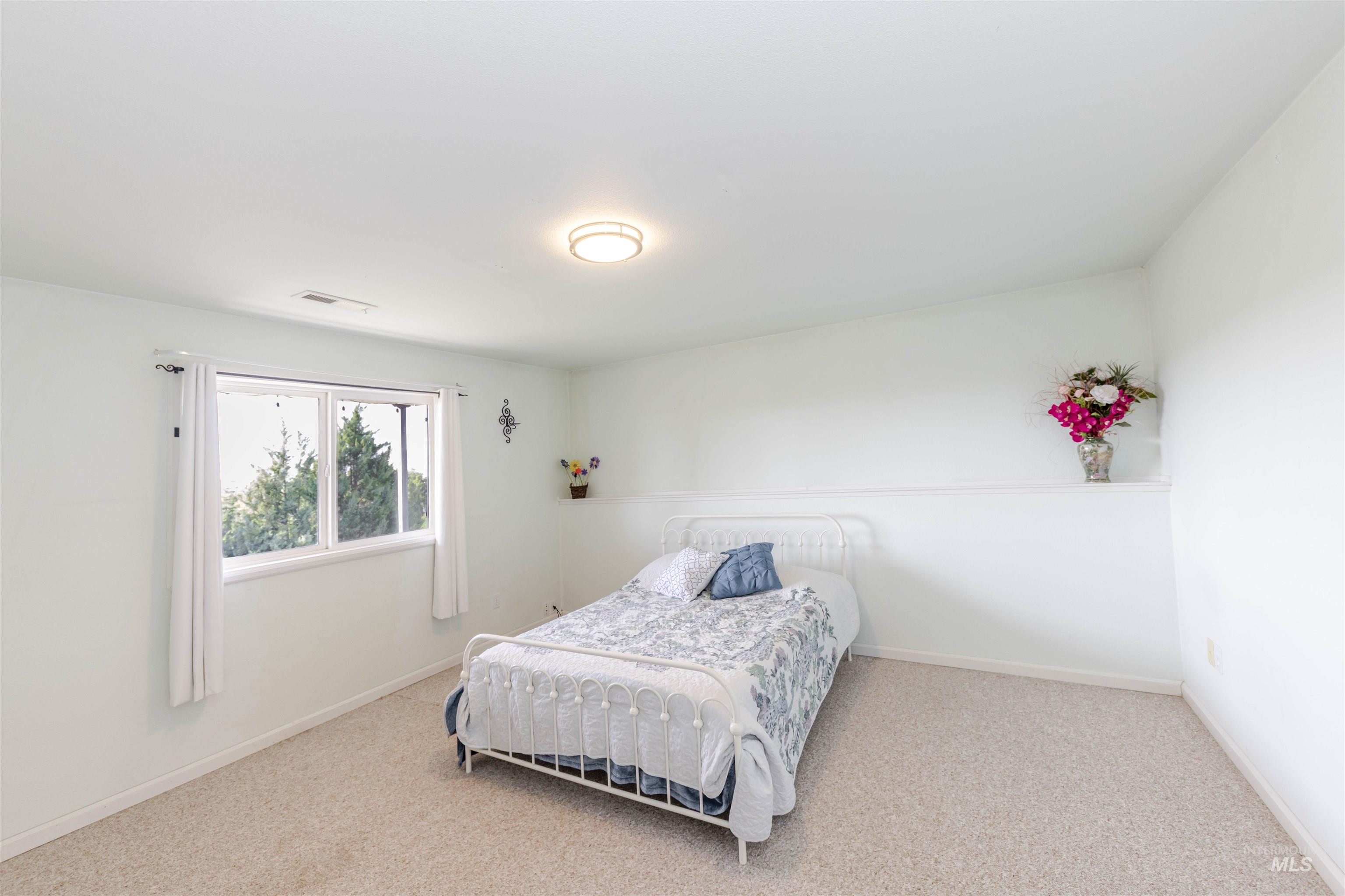 Carpeted bedroom featuring baseboards