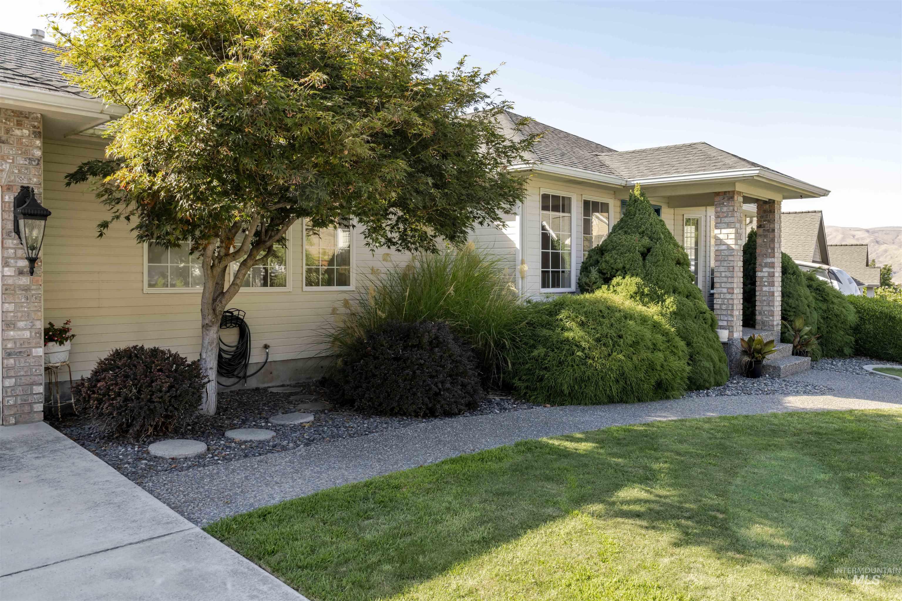 View of home's exterior featuring a lawn and roof with shingles
