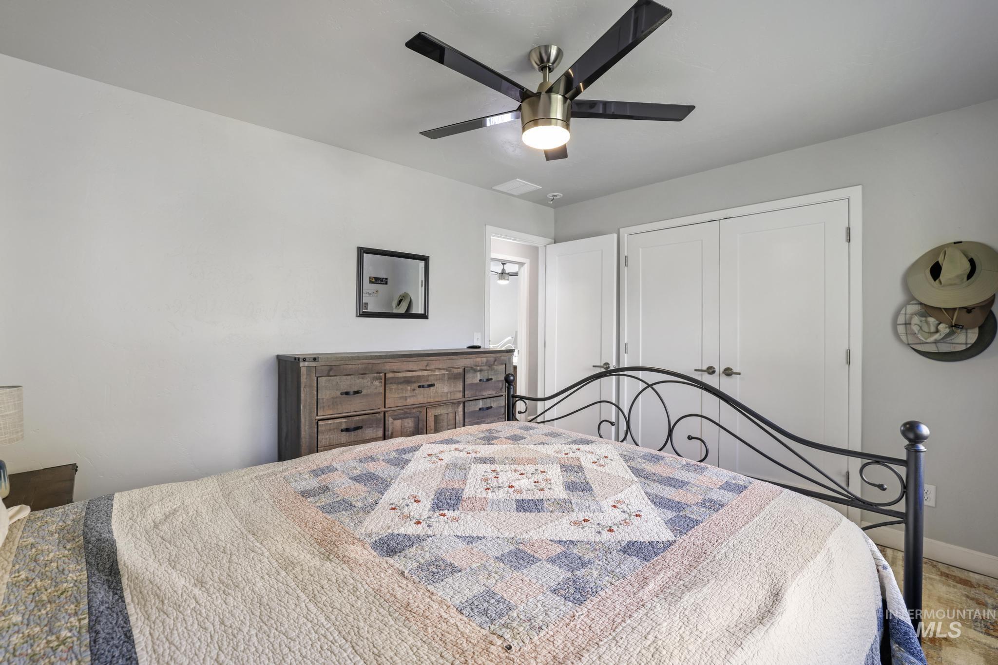 Bedroom with ceiling fan and a closet
