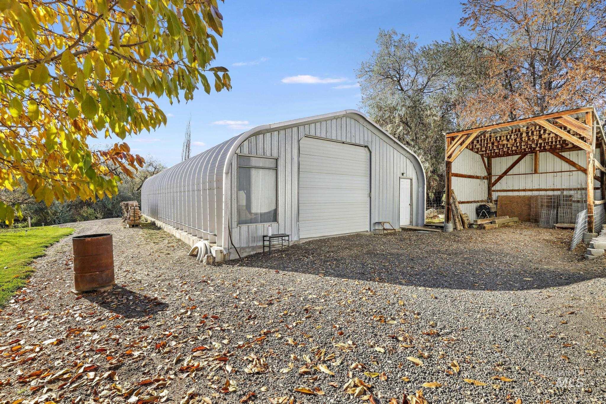 View of outbuilding featuring gravel driveway