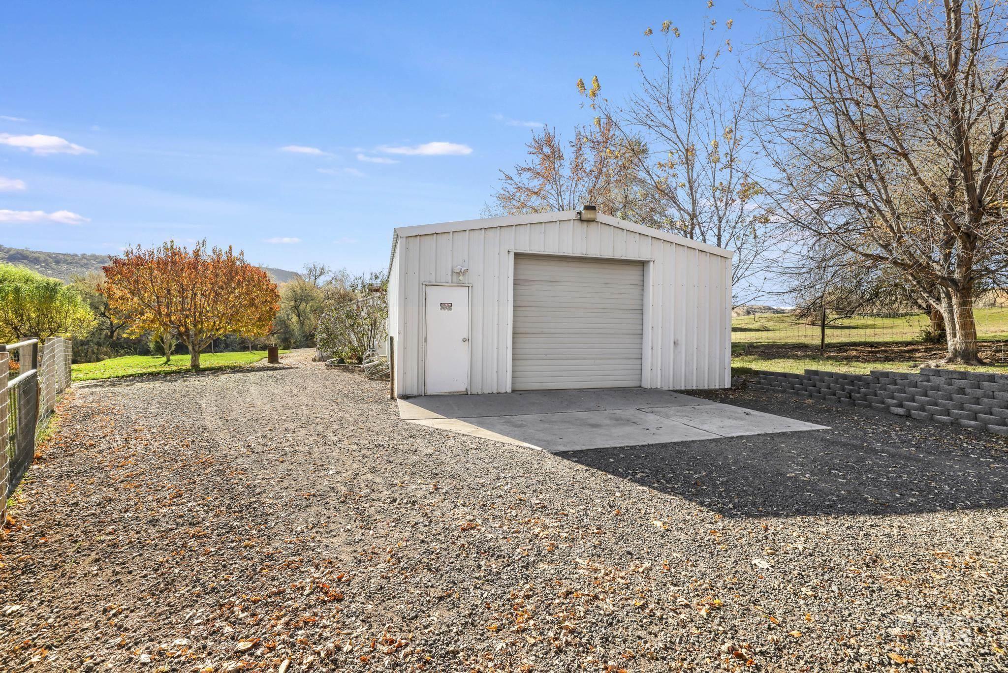 Garage featuring gravel driveway