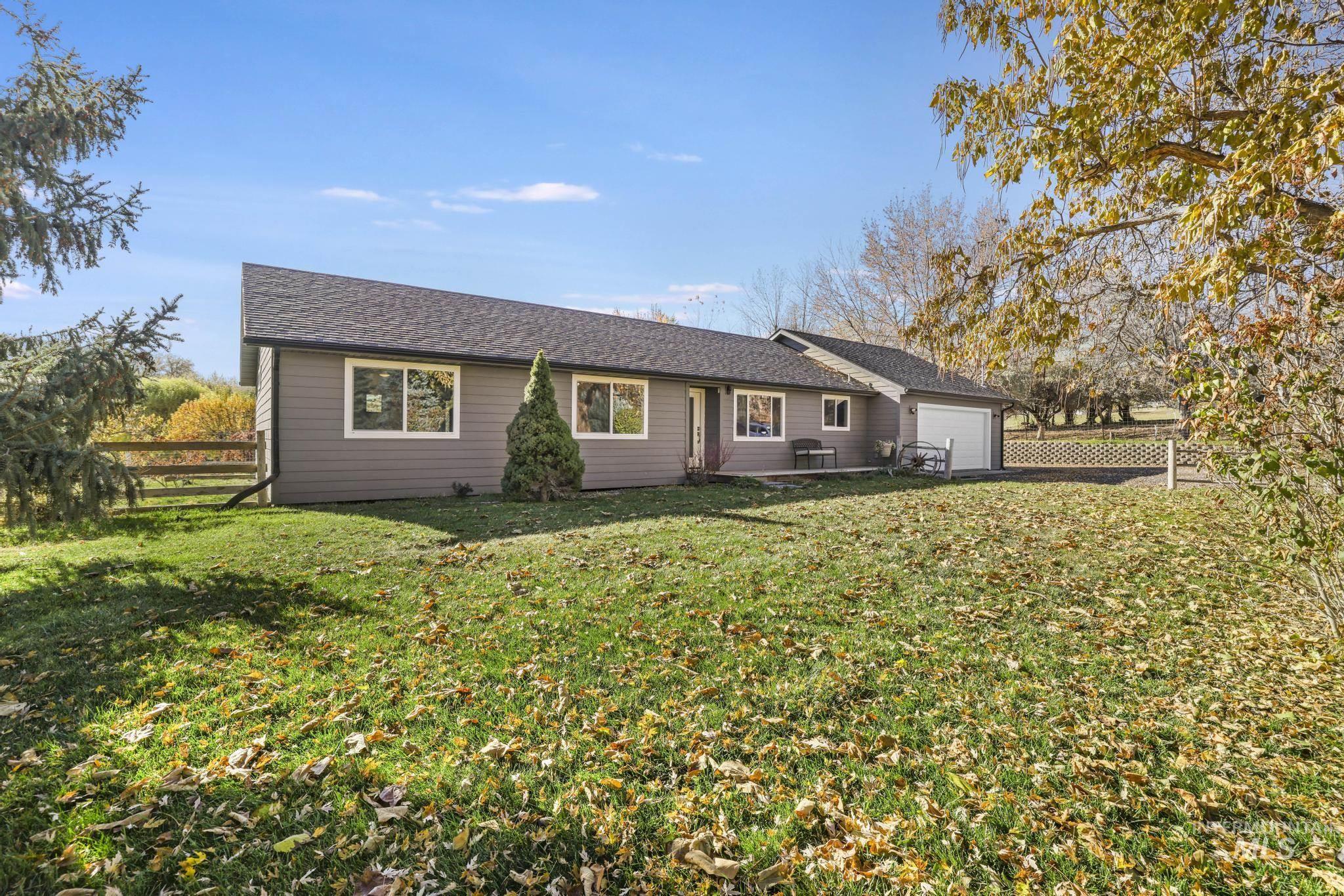 Single story home with an attached garage and roof with shingles