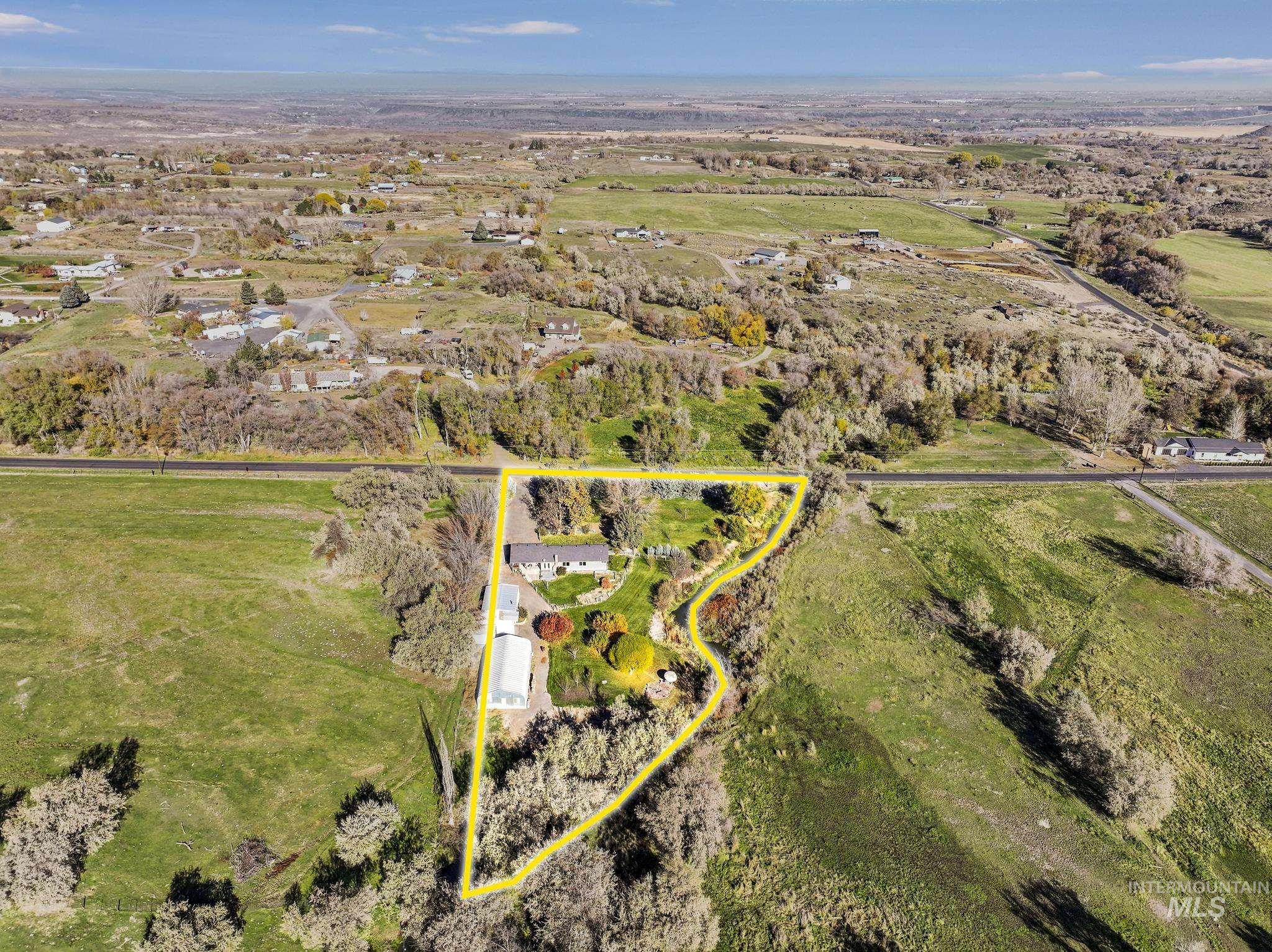 Aerial view of property and surrounding area with property boundaries highlighted