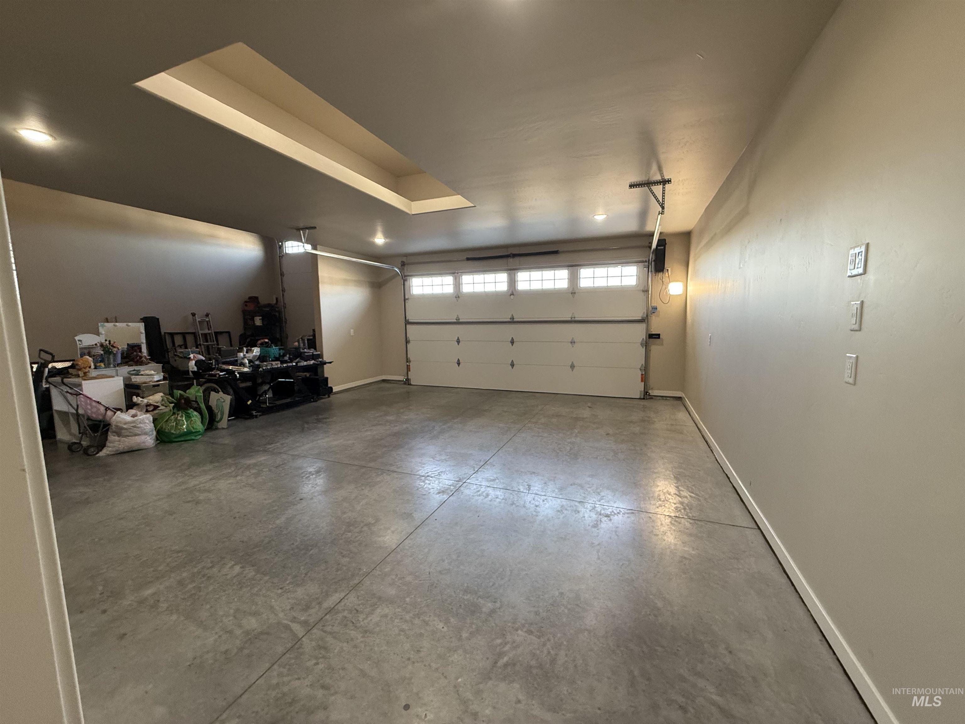 Garage featuring baseboards