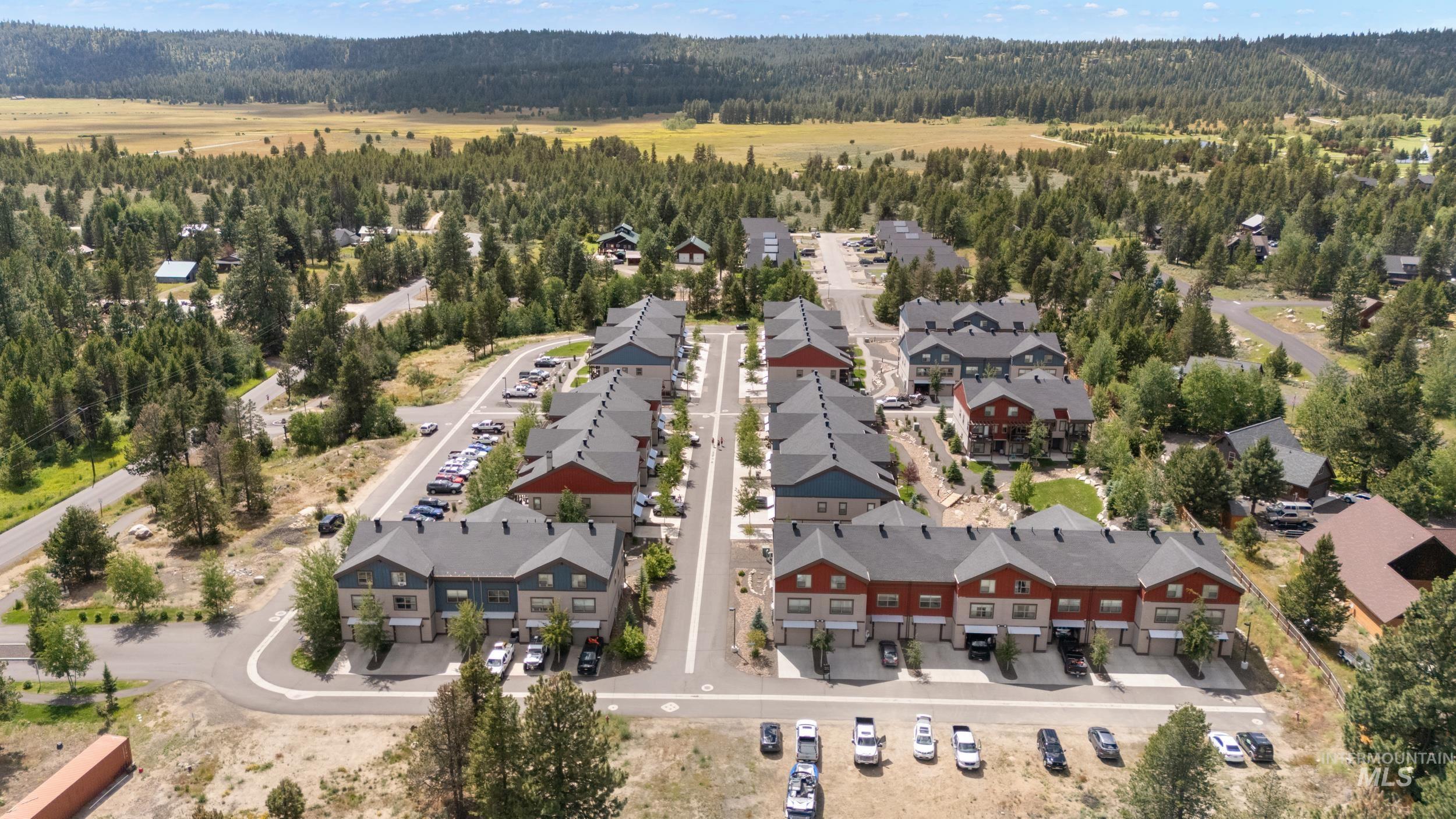 Townhome community featuring contemporary architecture, paved roadways, and integrated parking