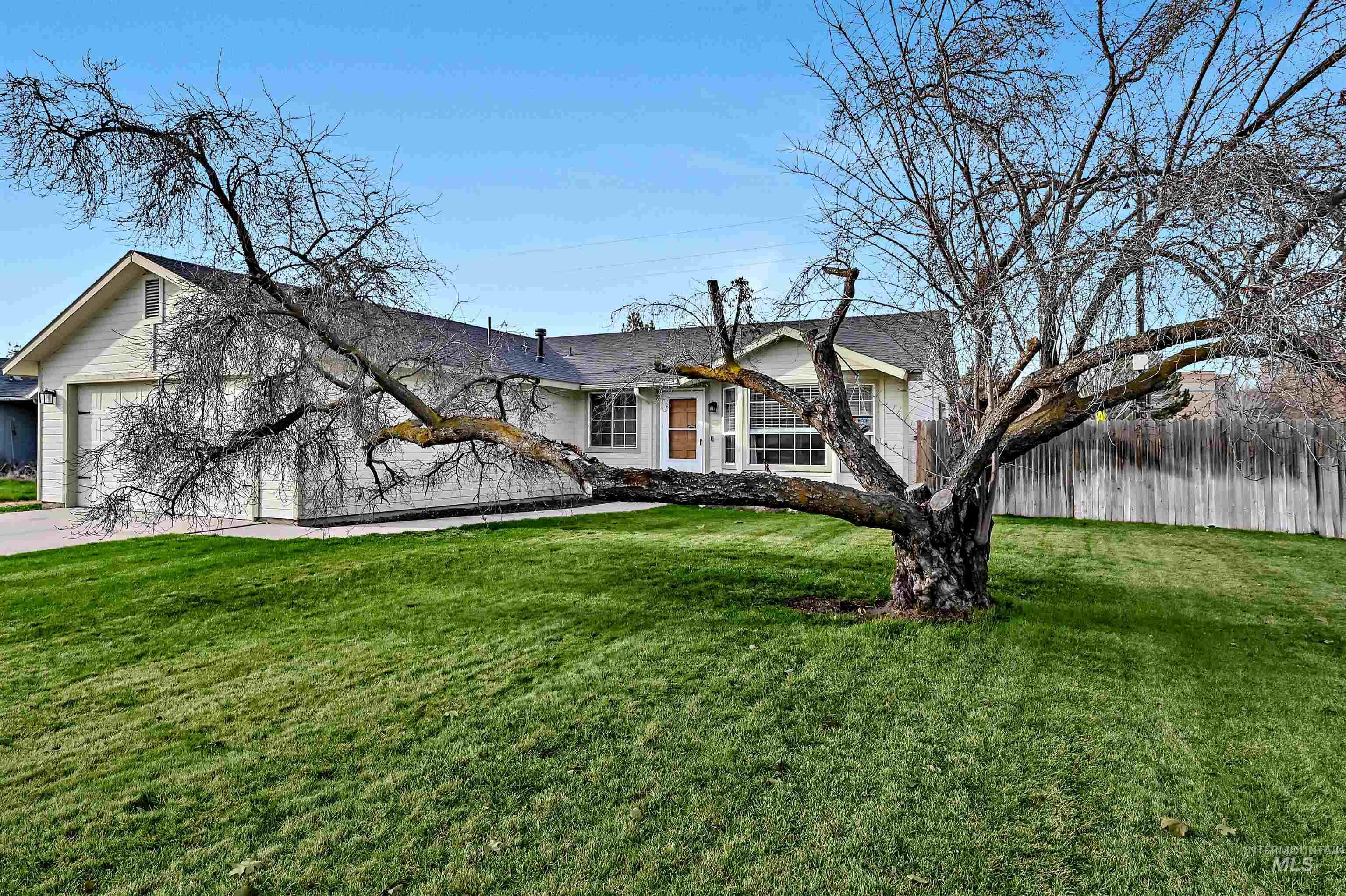 Ranch-style home with an attached garage and concrete driveway